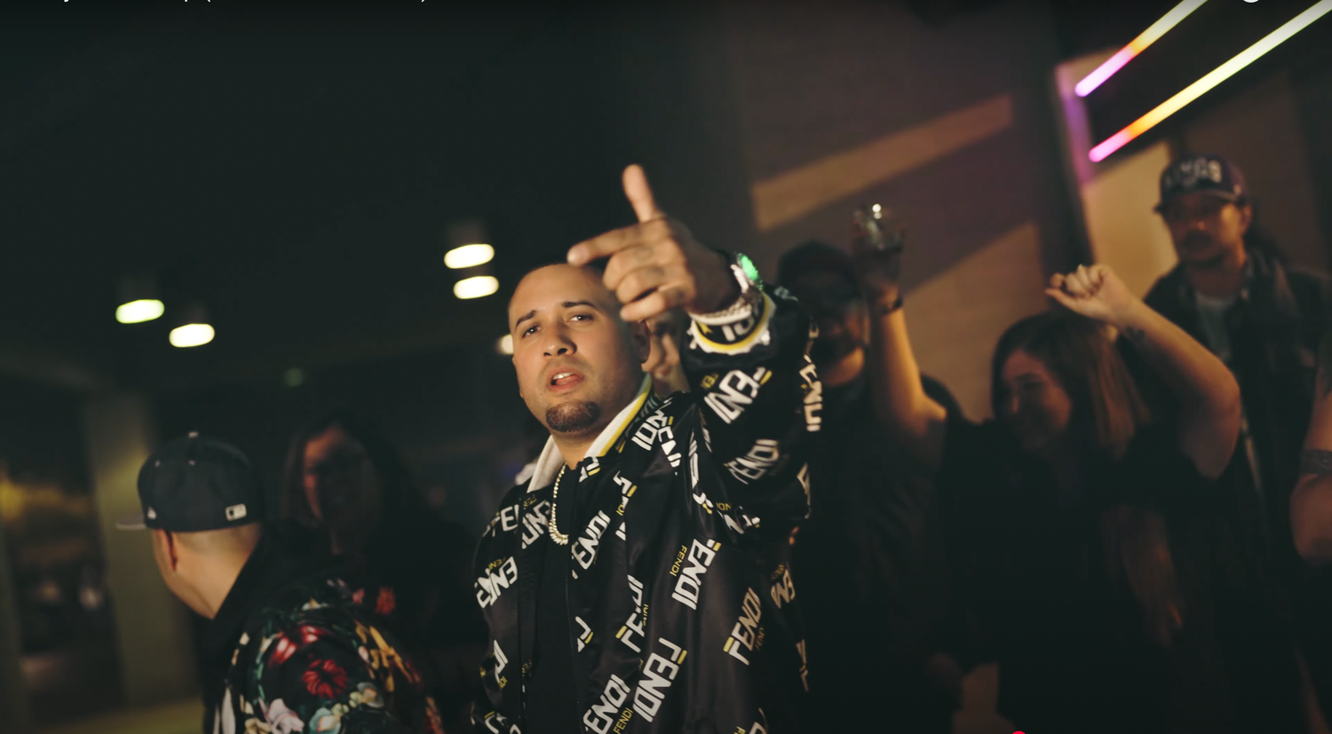 People dancing and celebrating in a dimly lit club setting with Japanese-inspired black and white patterned clothing.