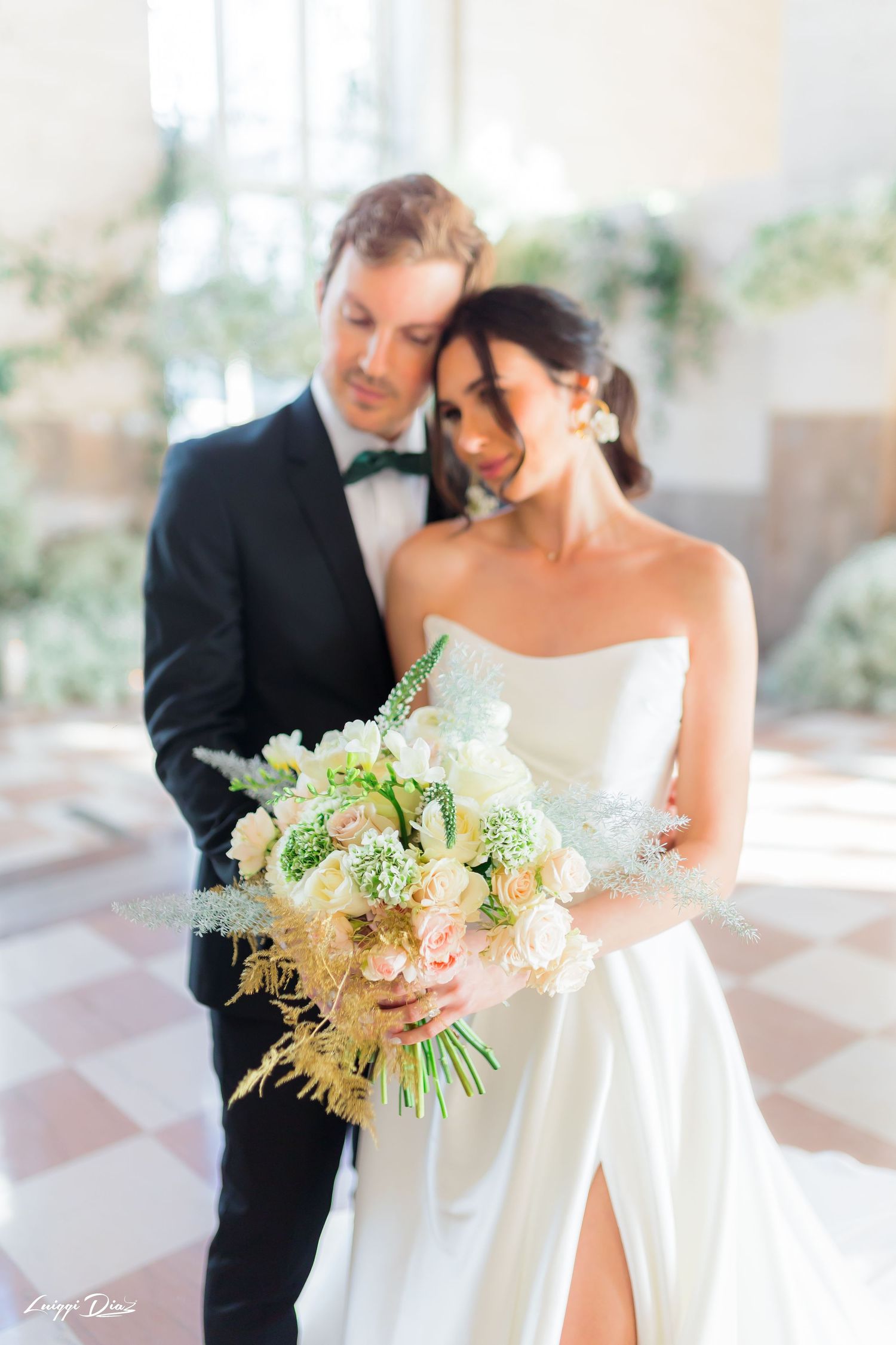Tender wedding moment with a beautiful bouquet of pastel flowers.