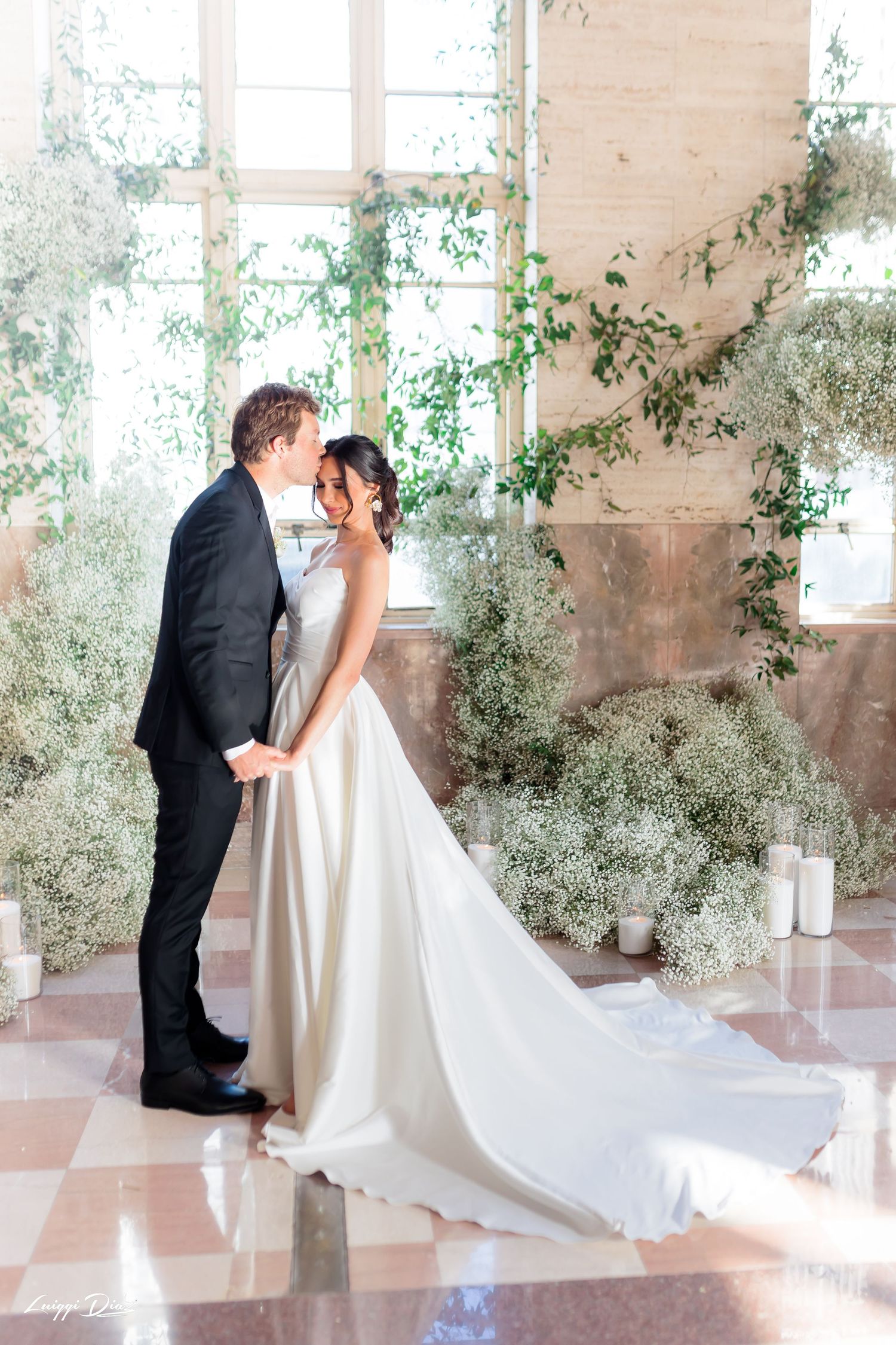 Romantic moment in sunlit room decorated with ethereal baby's breath arrangements.