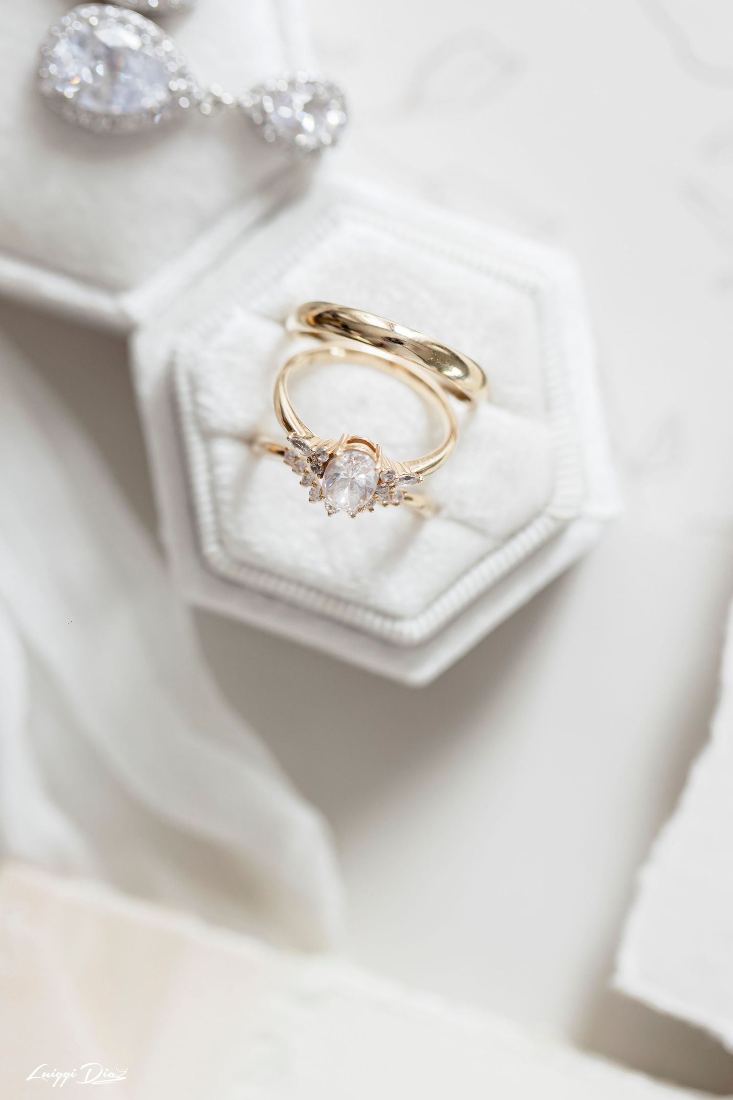 Elegant engagement ring with diamond centerpiece displayed in white hexagonal box.
