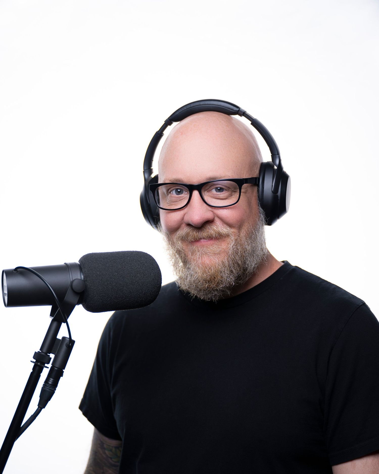 Person in black shirt wearing headphones and glasses shown in four different poses against white background.