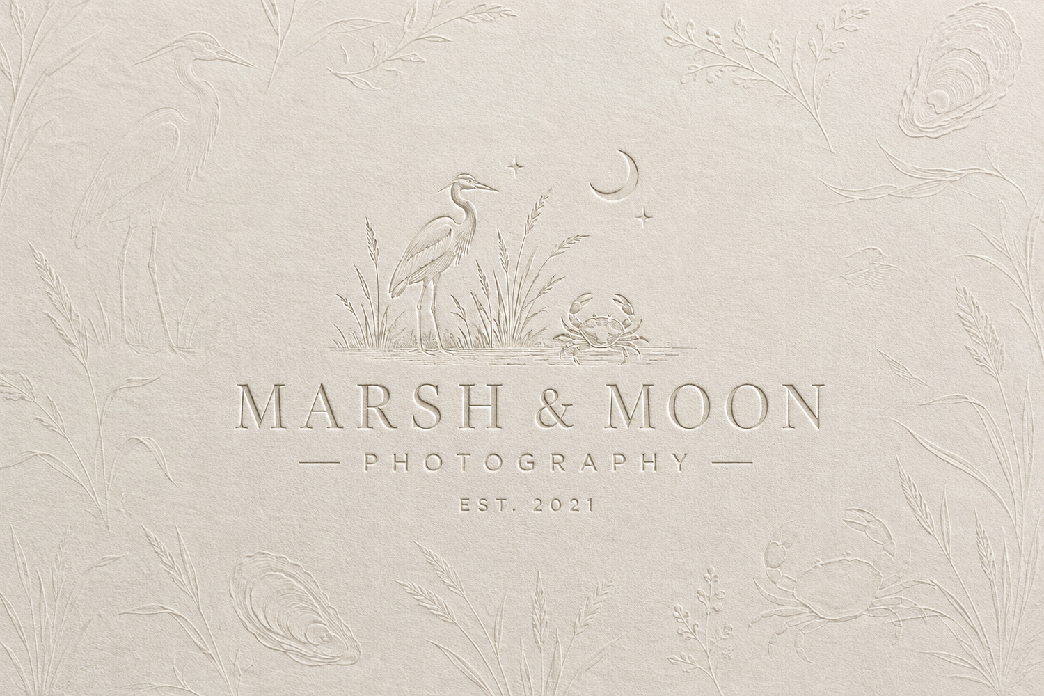 Marsh & Moon Photography logo embossed on textured cream paper featuring a heron illustration with moon and Est. 2011.