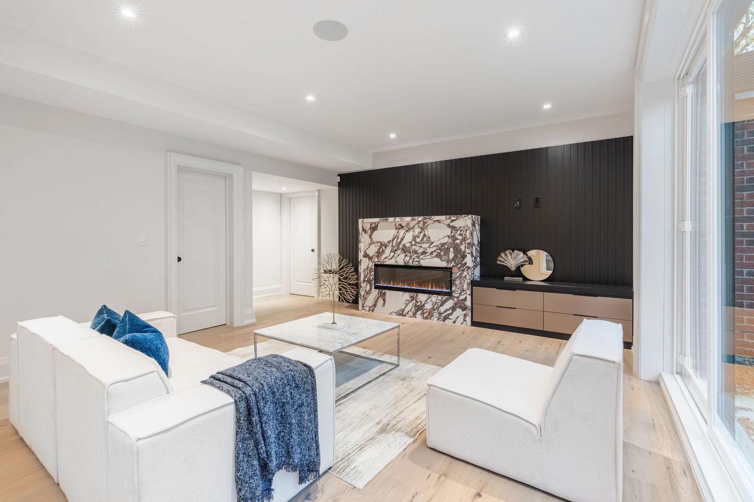 Modern bedroom interior with white walls, blue accents, and minimalist design elements.