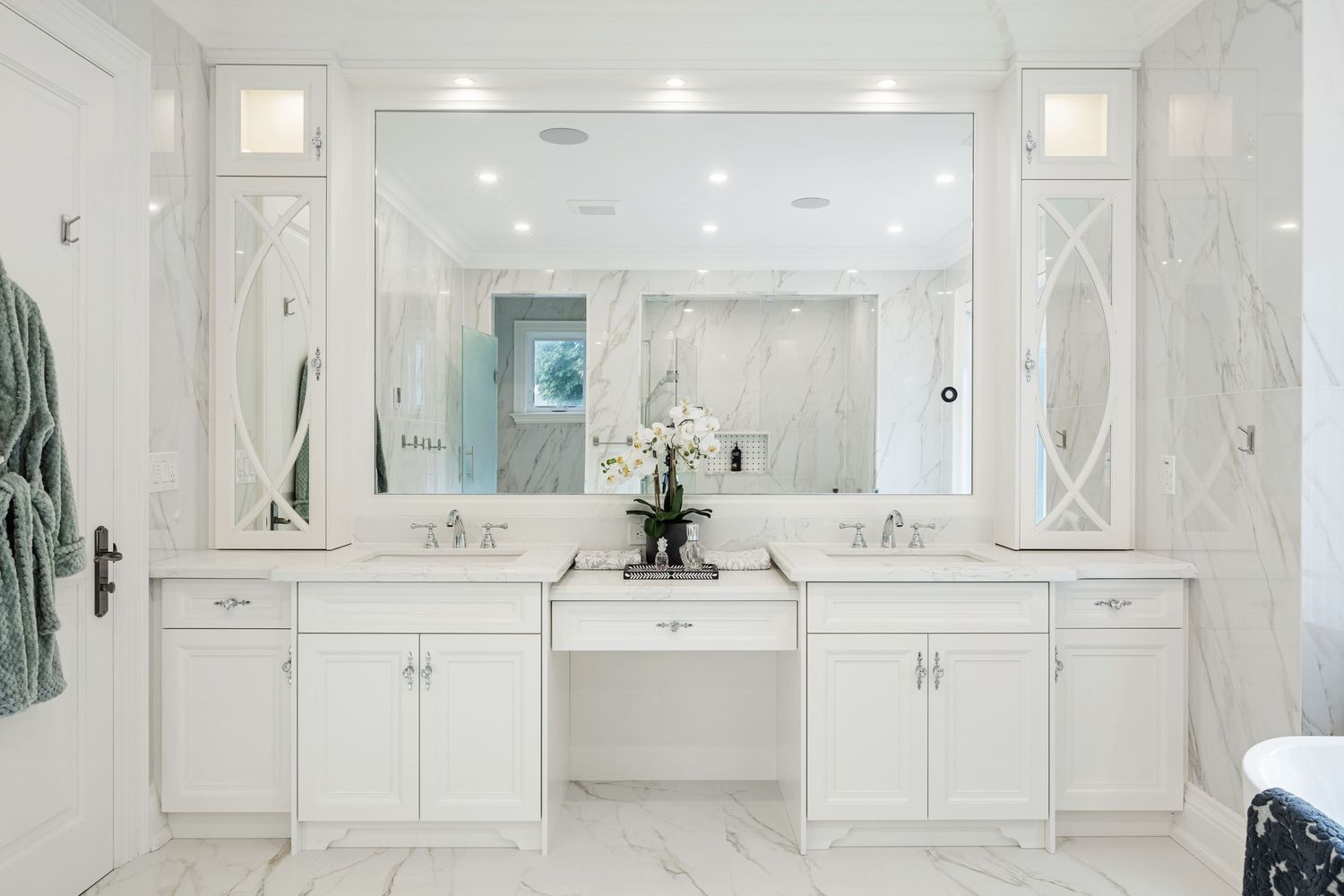 Modern master bathroom with marble floors and custom cabinetry in luxury estate