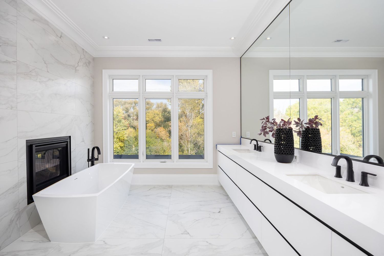 Spacious white bathroom with multiple windows and contemporary design elements.
