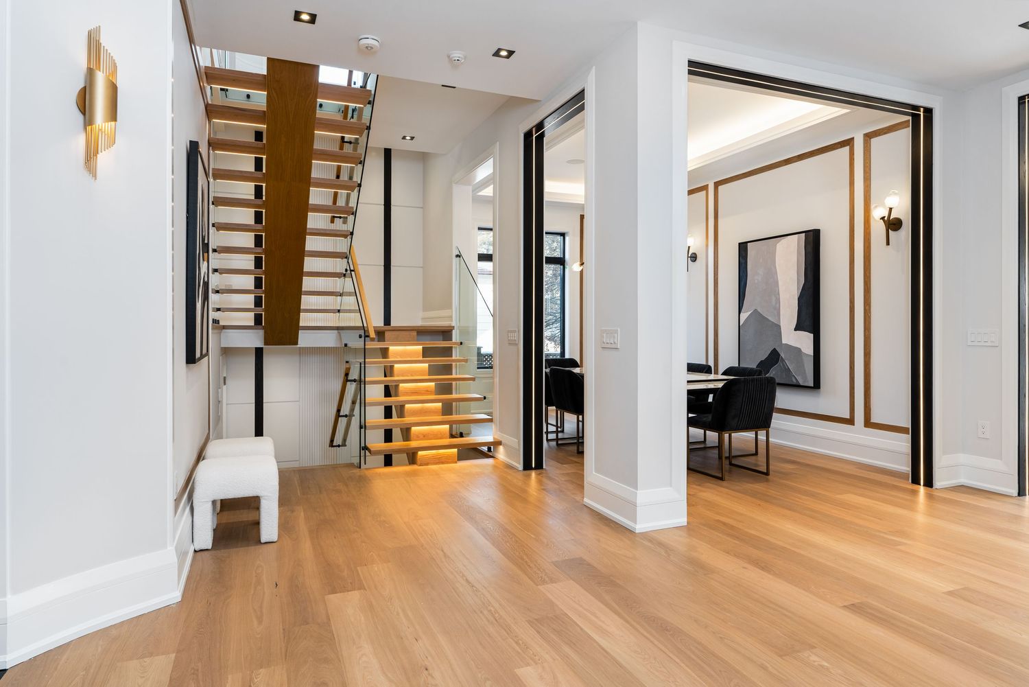 Long hallway with hardwood flooring, recessed lighting, and modern architectural details.