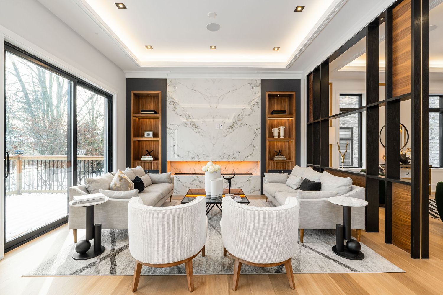 Luxurious dining area with white marble walls, modern seating, and panoramic windows.