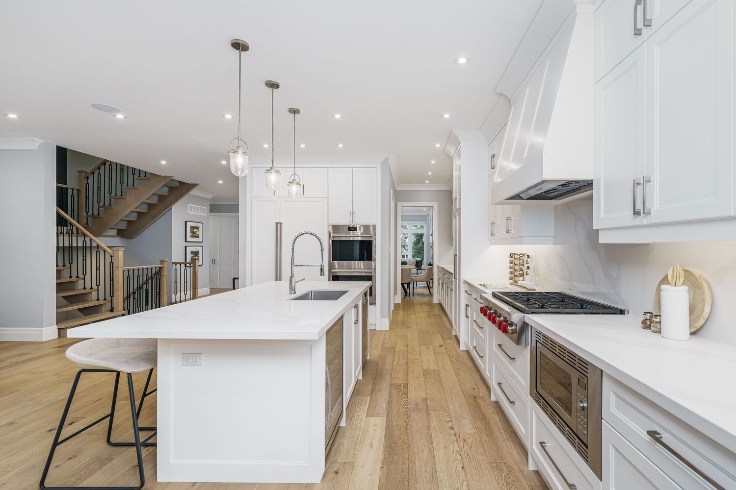 Modern open concept home interior features white walls, hardwood floors and minimalist contemporary design elements.