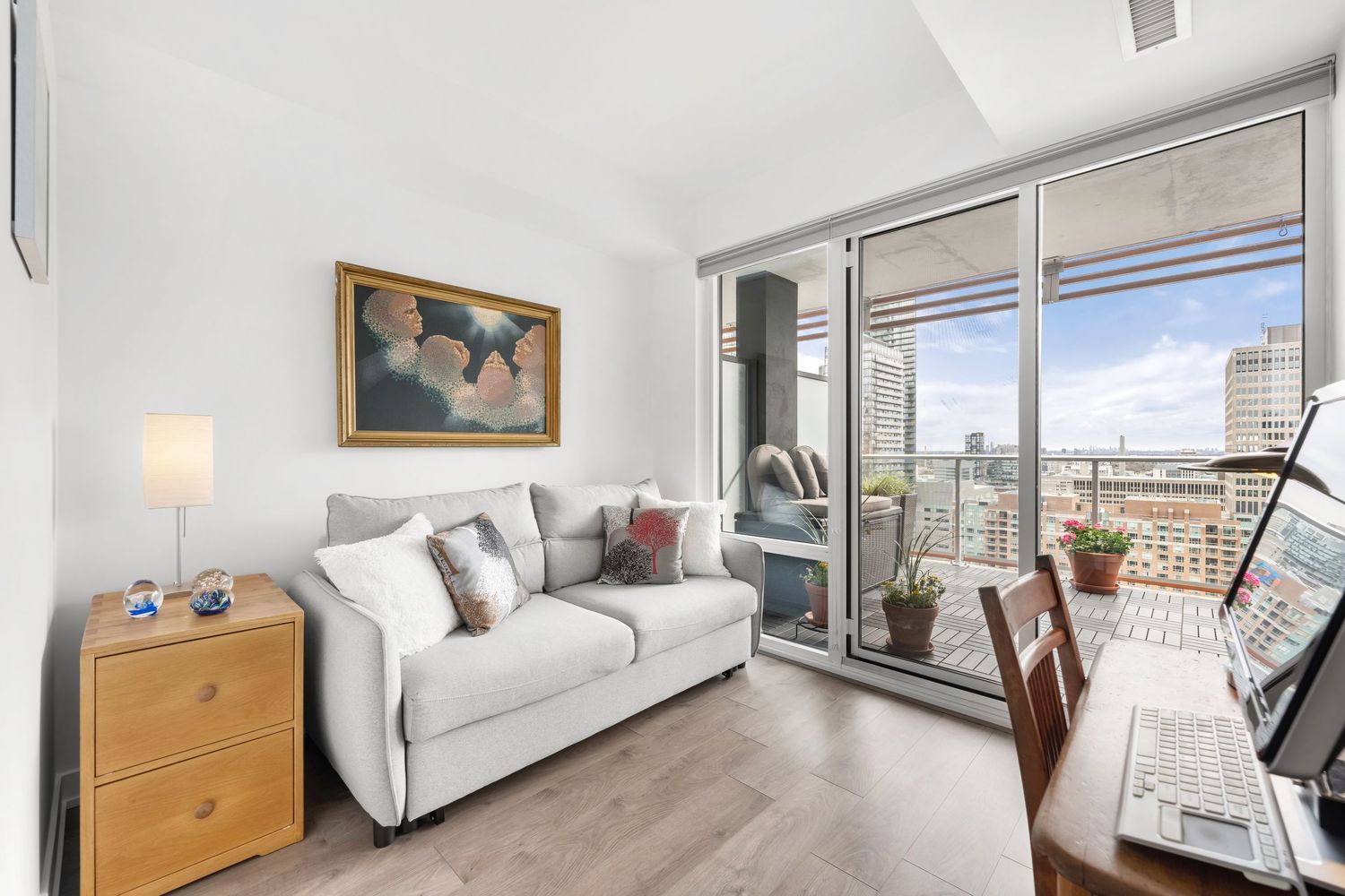 A modern apartment interior photo collage showing white furniture, wood accents, and large windows with city views.