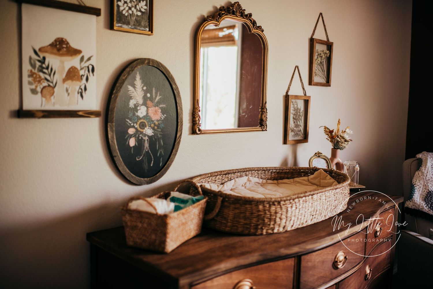 Vintage-style wooden dresser with decorative oval mirror and rustic decor elements against a neutral wall.