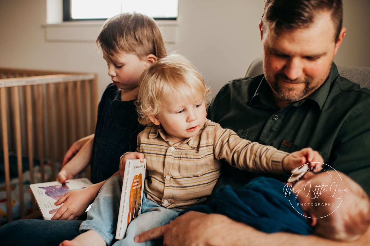 A tender family moment shared while reading a book together on a couch.