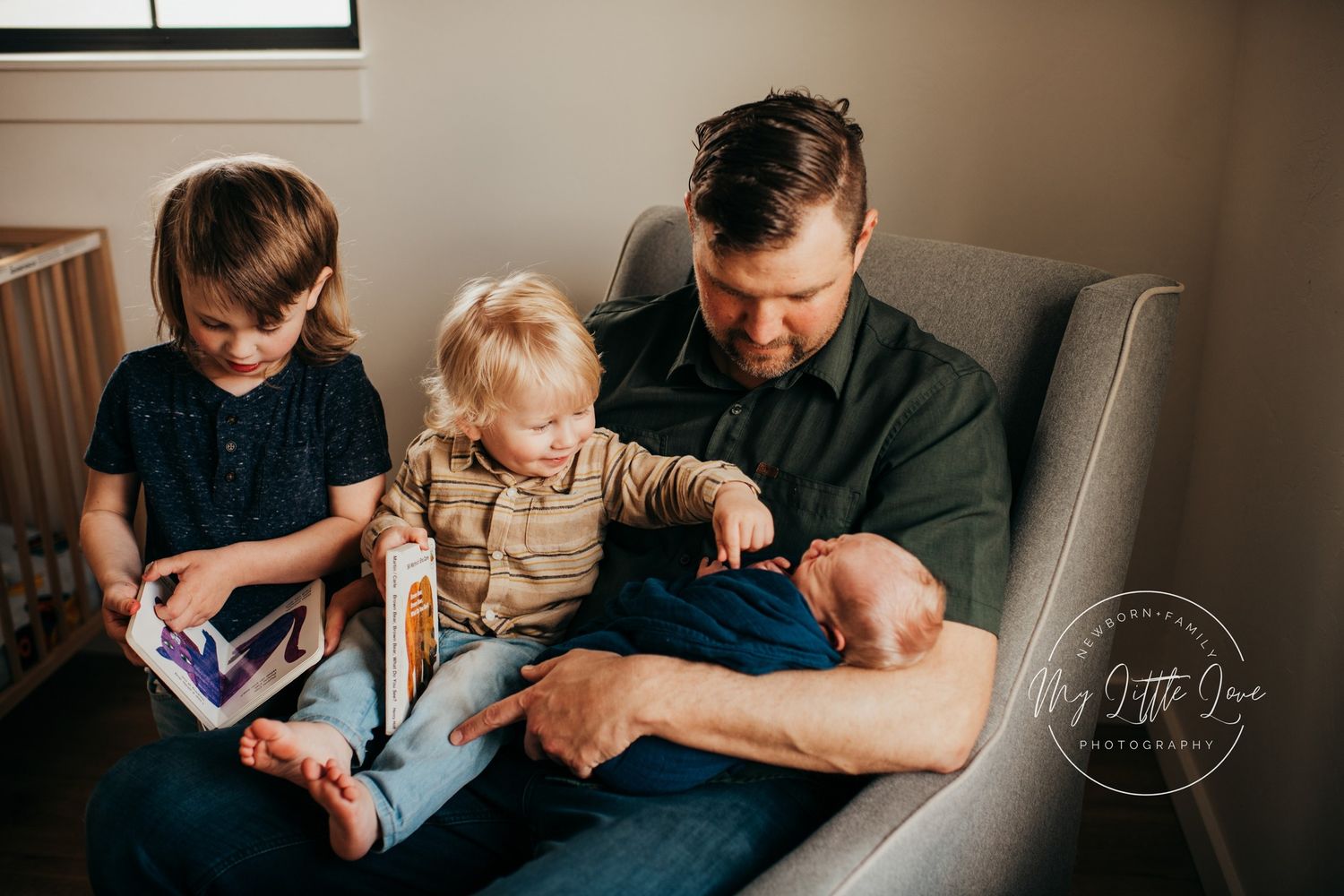 A cozy family moment on a grey sofa with books and quality time together.
