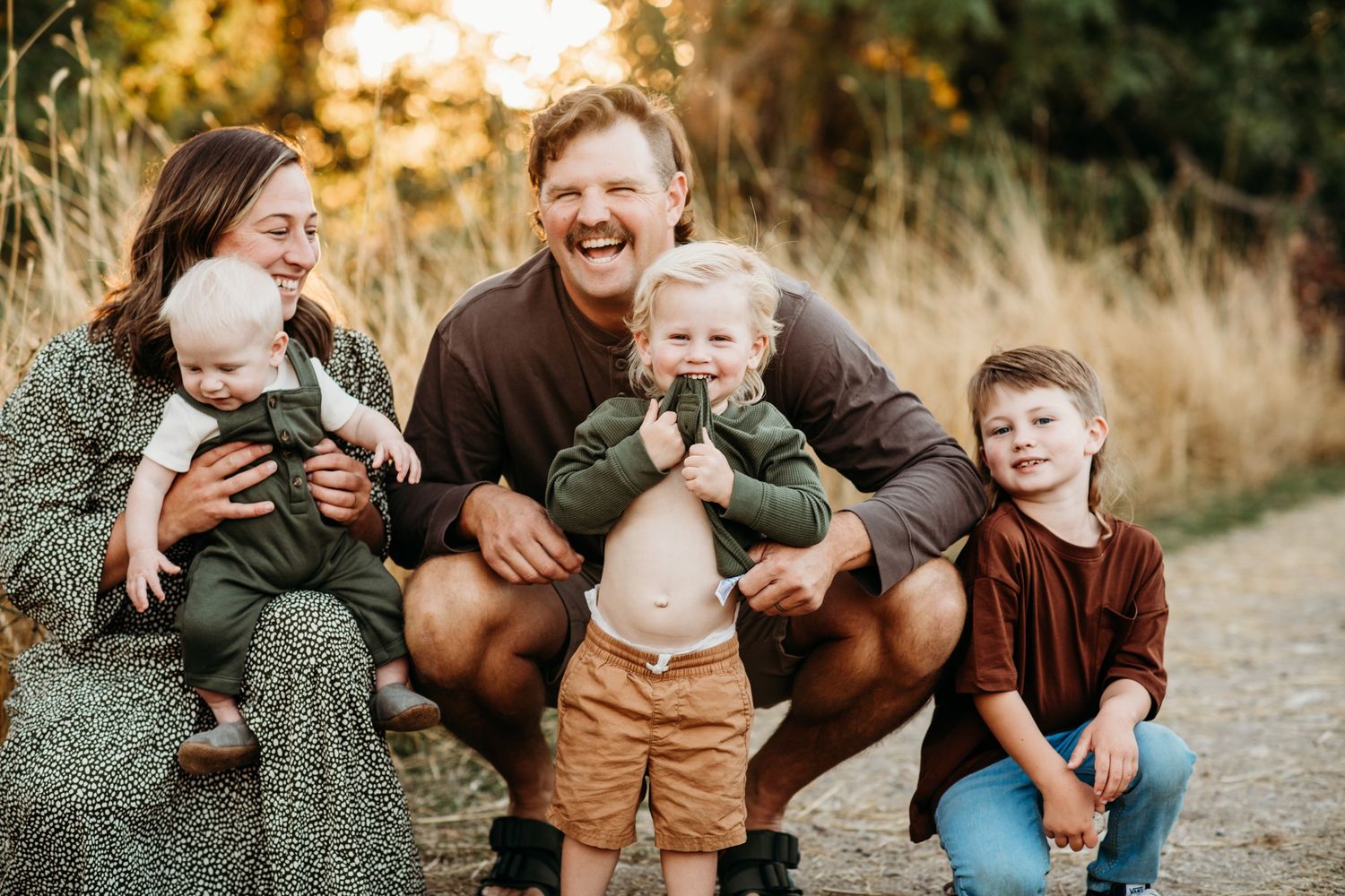 Family shares joyful moment together outdoors during autumn photoshoot.