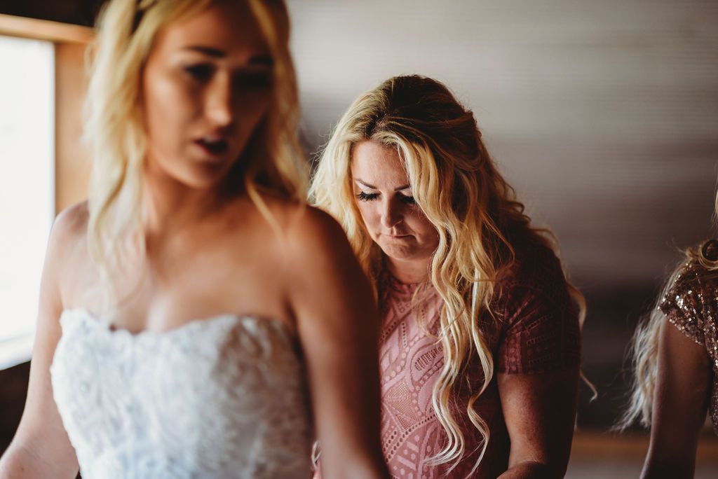Candid moment of laughter and joy during wedding preparations.