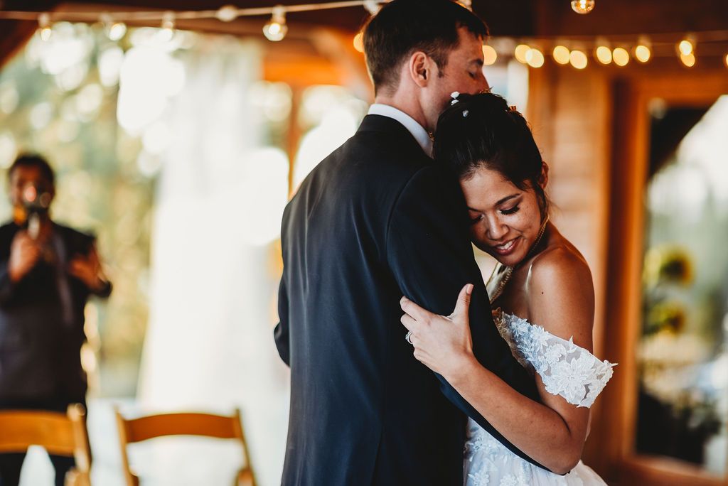 A romantic first dance moment at a wedding reception with string lights creating a warm ambiance.