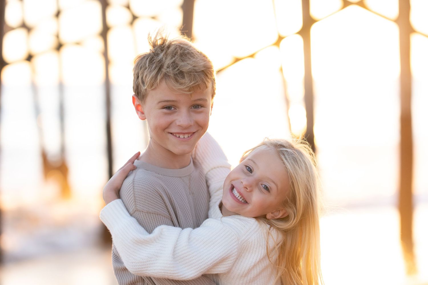 A loving family shares joyful moments together in a sunlit forest during golden hour.