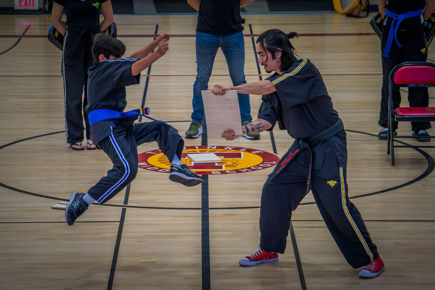 Students participating in physical education activities in school gymnasium.