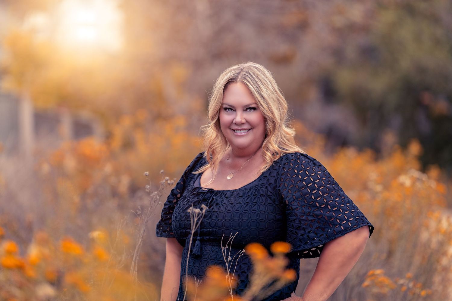 Autumn outdoor portrait with golden sunlight and natural bokeh background.