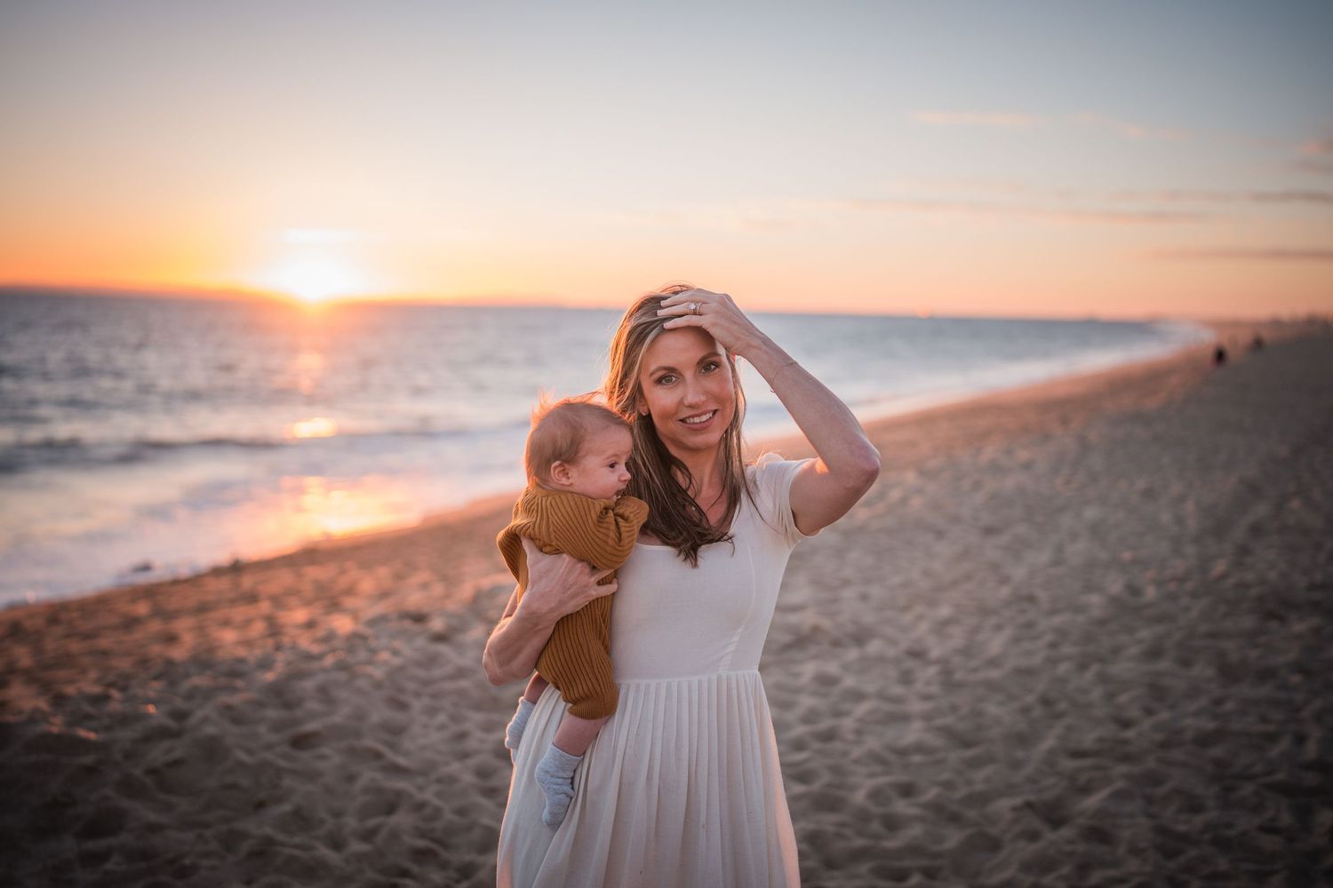 A series of romantic beach sunset photos showing a couple walking along the shore and embracing in golden light.