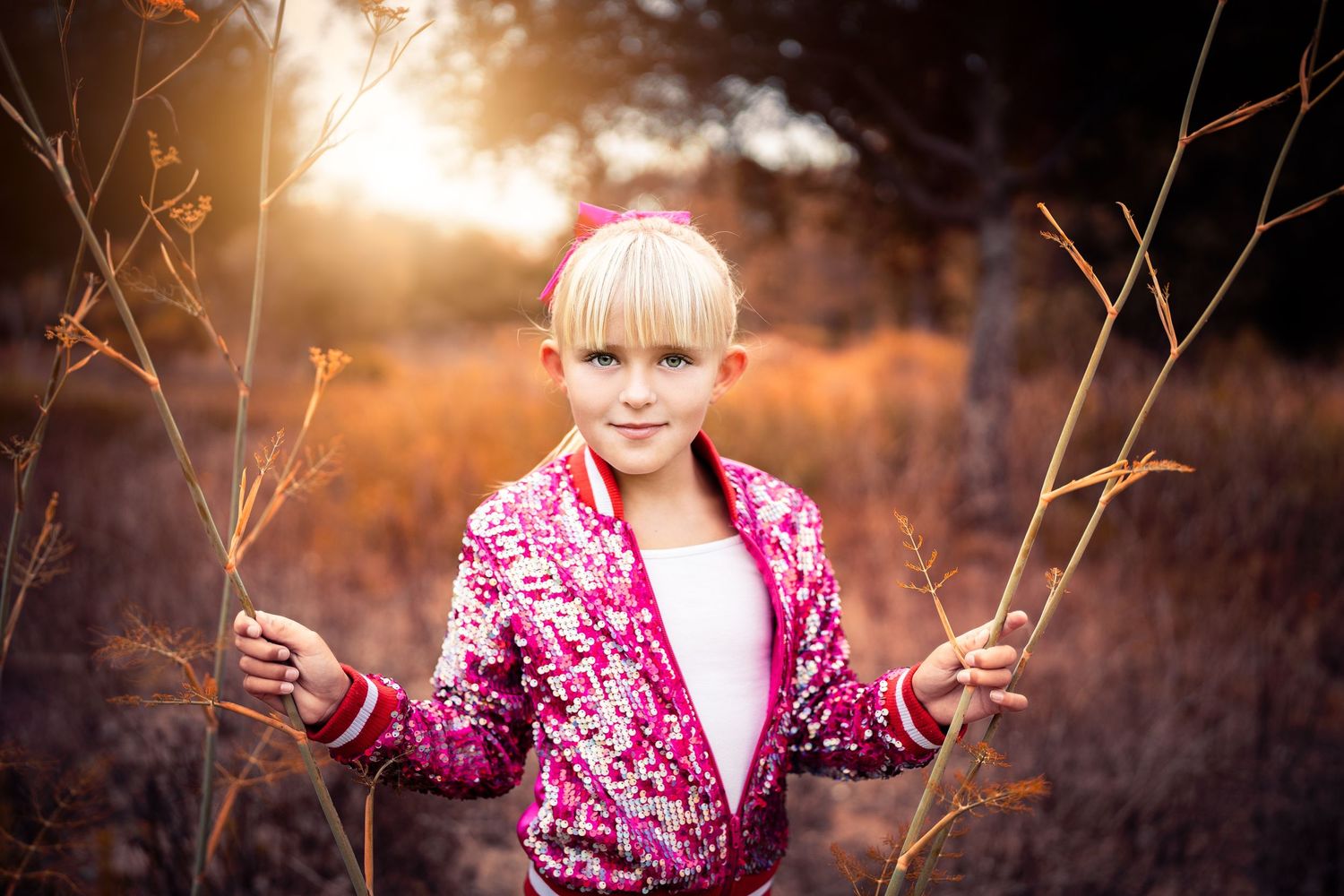 Dramatic portrait in nature with lens flare and warm sunset lighting.