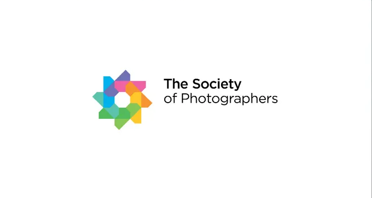 The Society of Photographers logo featuring a colorful floral emblem in rainbow hues on a white background.