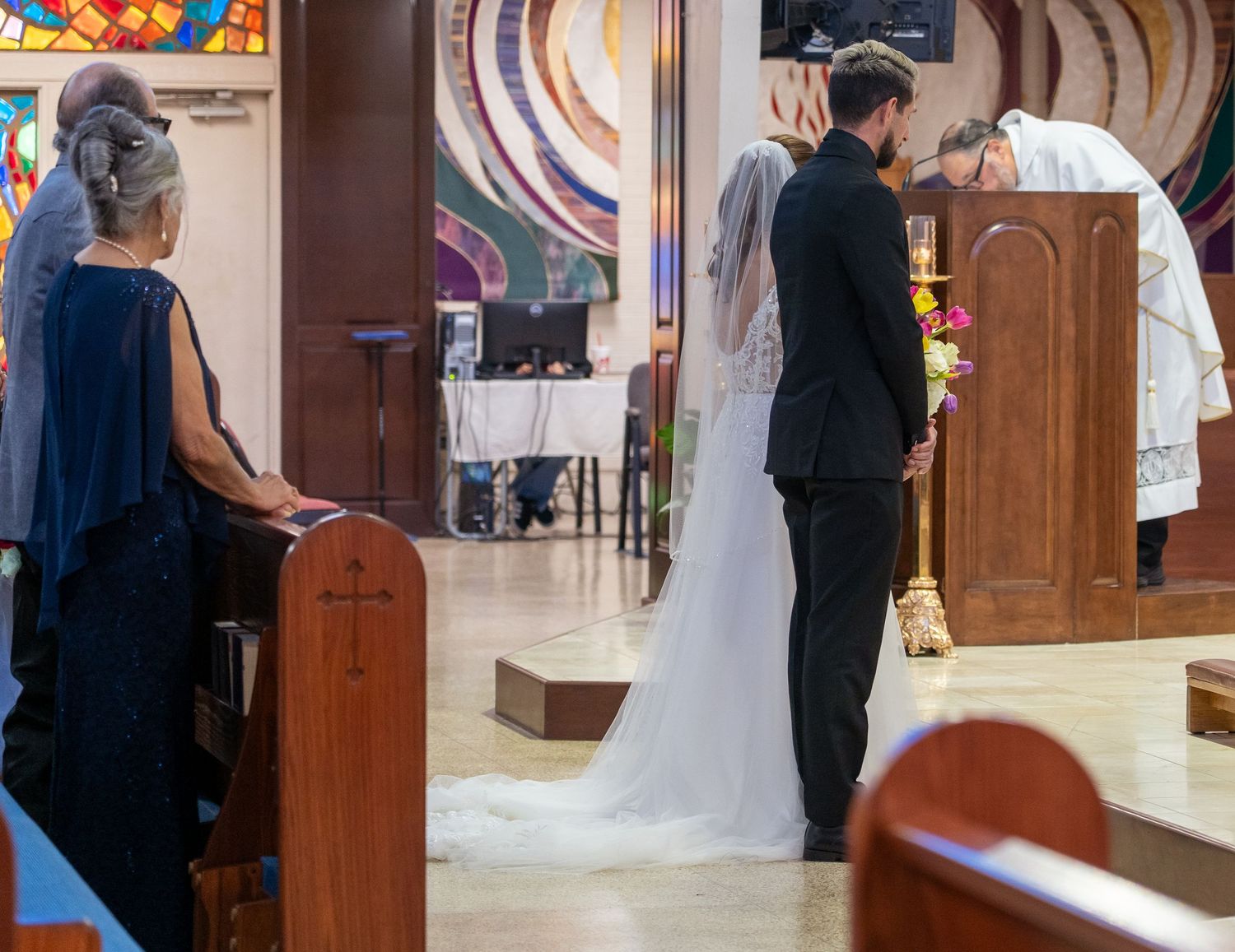 Wedding ceremony procession shown in sequential photos as couple walks down church aisle with attendants.