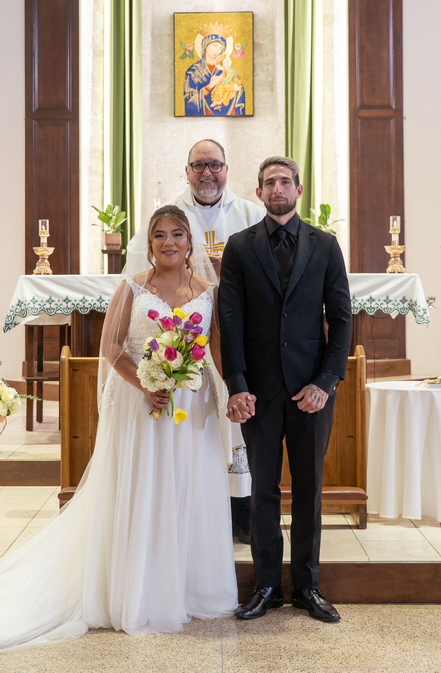 Four wedding photos showing couples standing together in a church with white walls and religious artwork.