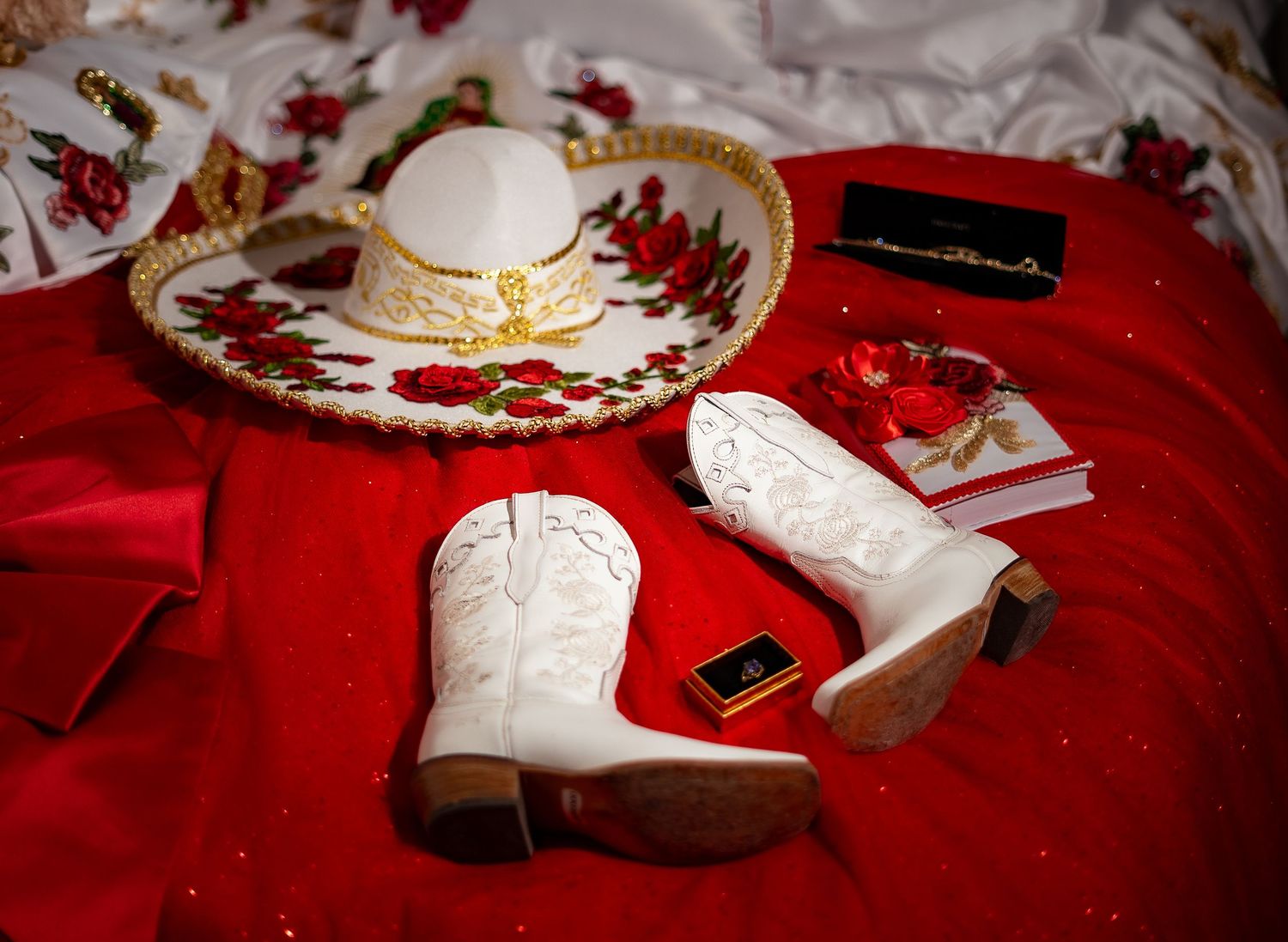 White porcelain plates with floral designs arranged on a red tablecloth with scattered decorative elements.