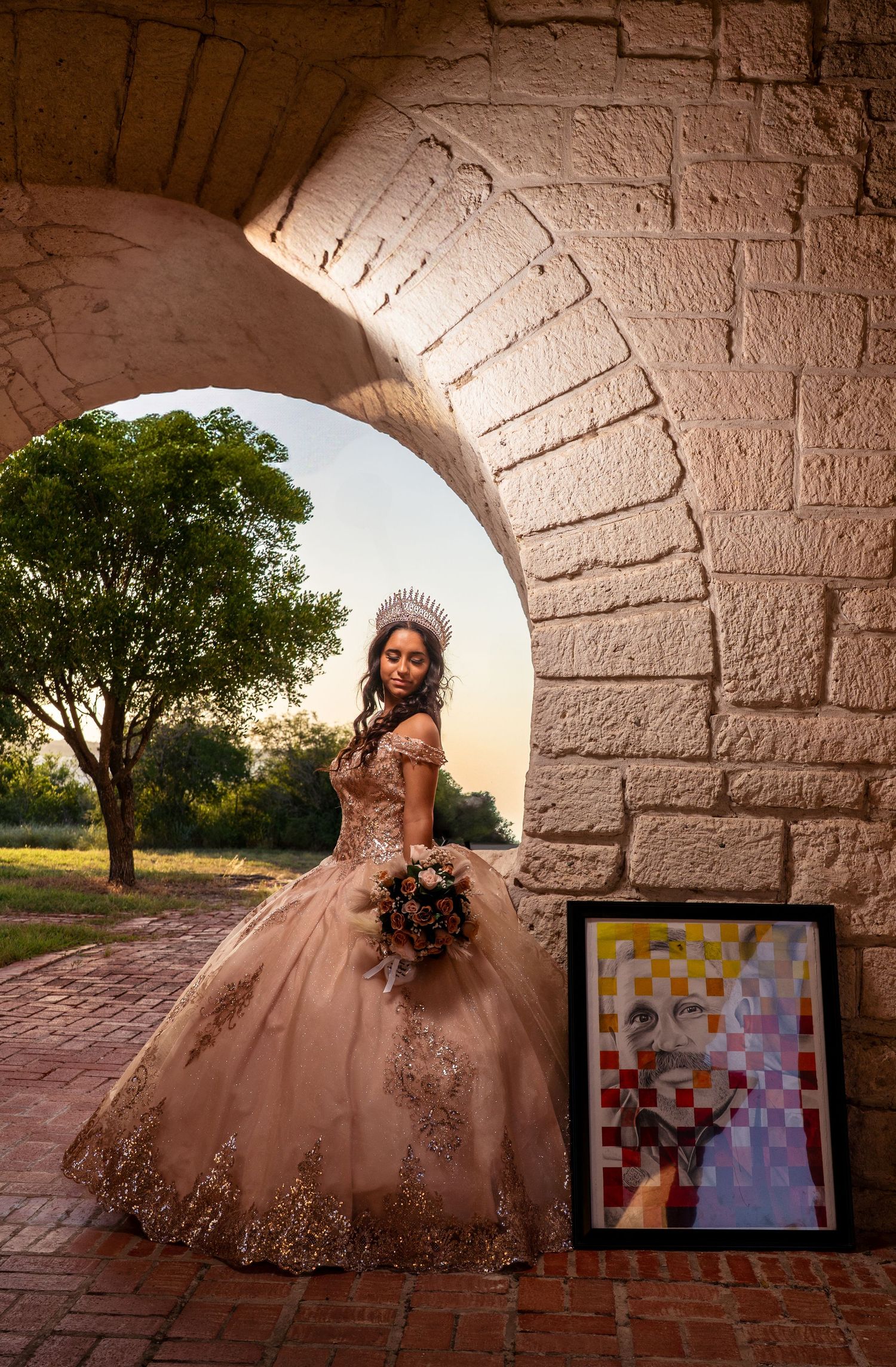 Four connected photos show a person in a blush pink ball gown posing in front of a stone archway at sunset.