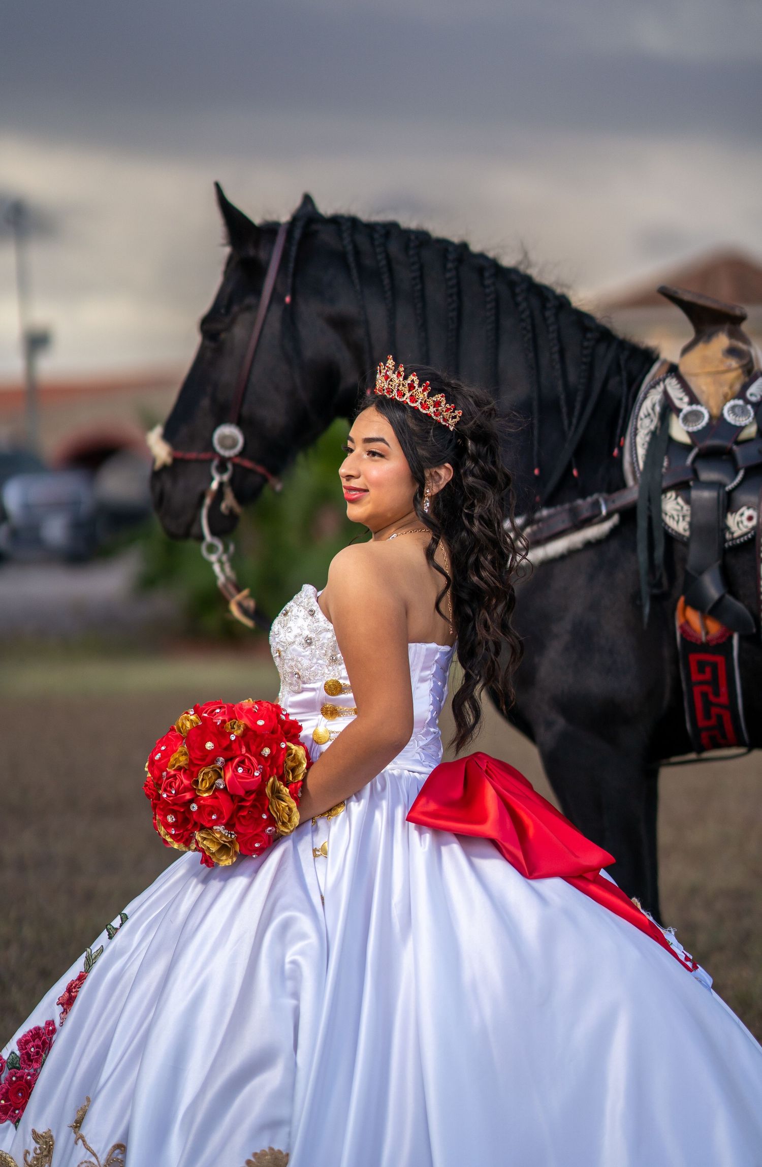 A sequence of photos showing a white quinceañera dress with red accents and roses against a dramatic sky.