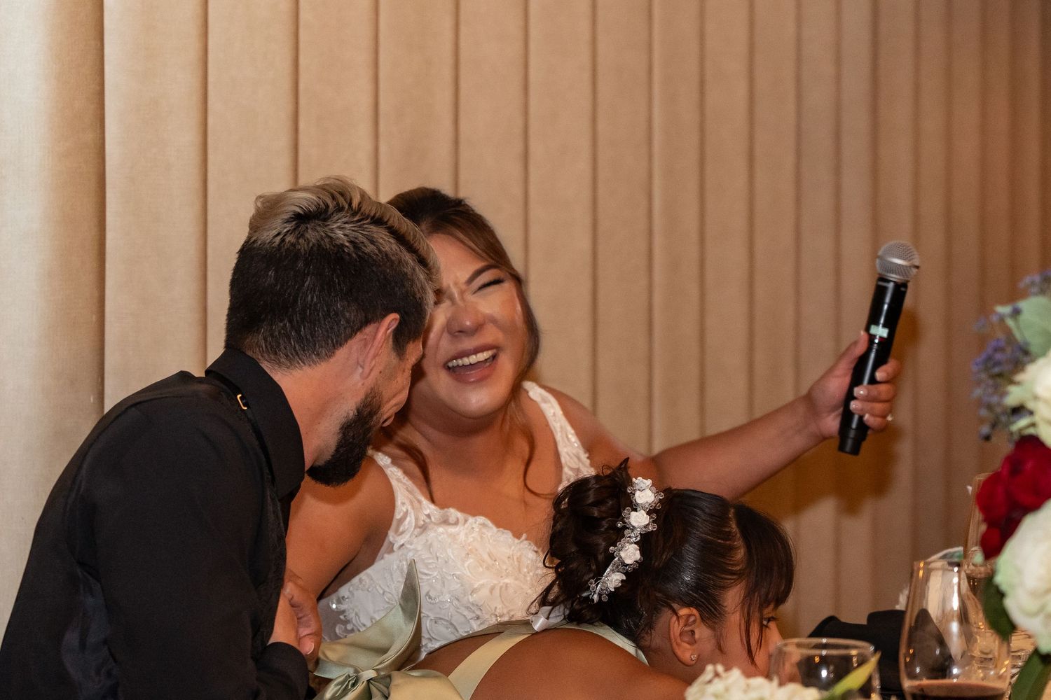 Wedding reception guests celebrating and socializing at decorated tables.