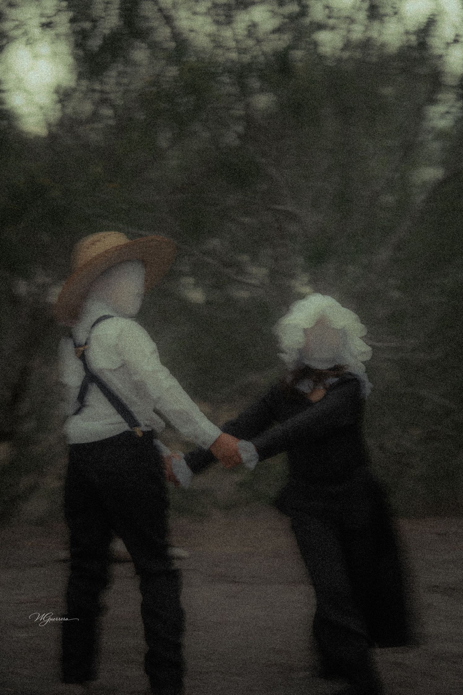 Two faceless figures in vintage attire hold hands in a blurred, atmospheric fine art dance photograph.