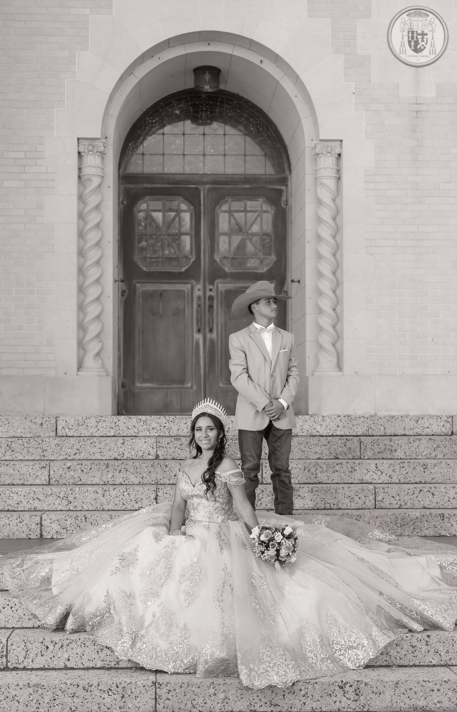 Black and white romantic wedding photos of a couple sitting on stone steps in front of ornate arched doorways.