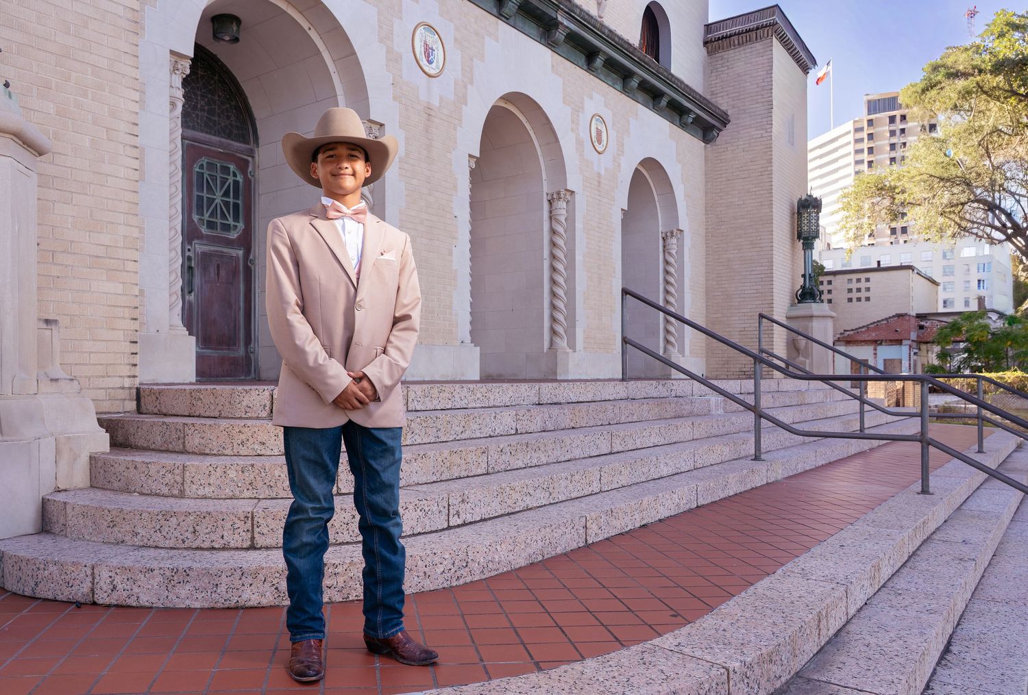 Multiple views of someone in western attire posing outside a historic brick building with Spanish-style architecture.
