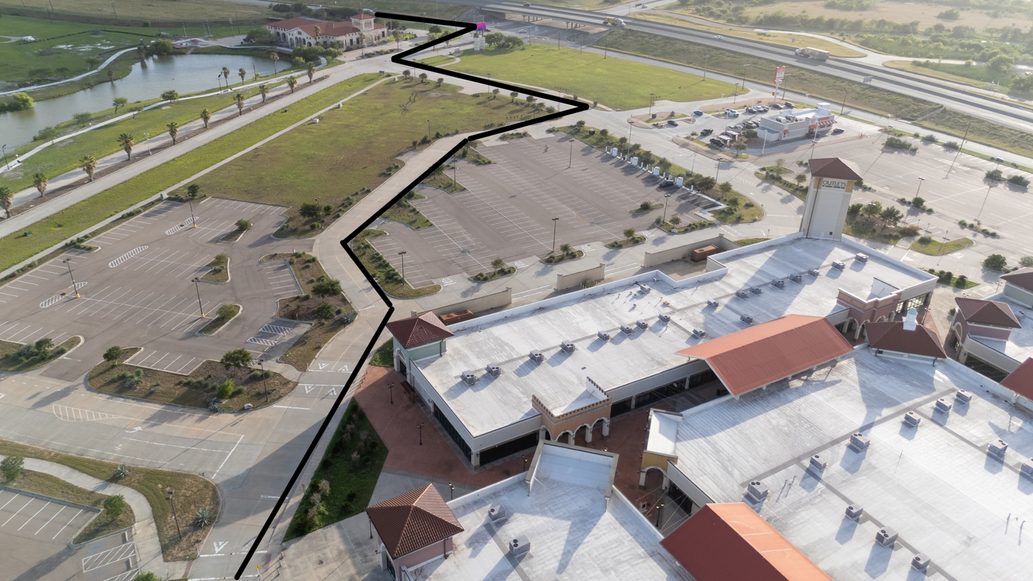 Aerial view of agricultural buildings and storage facilities with roads connecting multiple industrial structures on farmland.