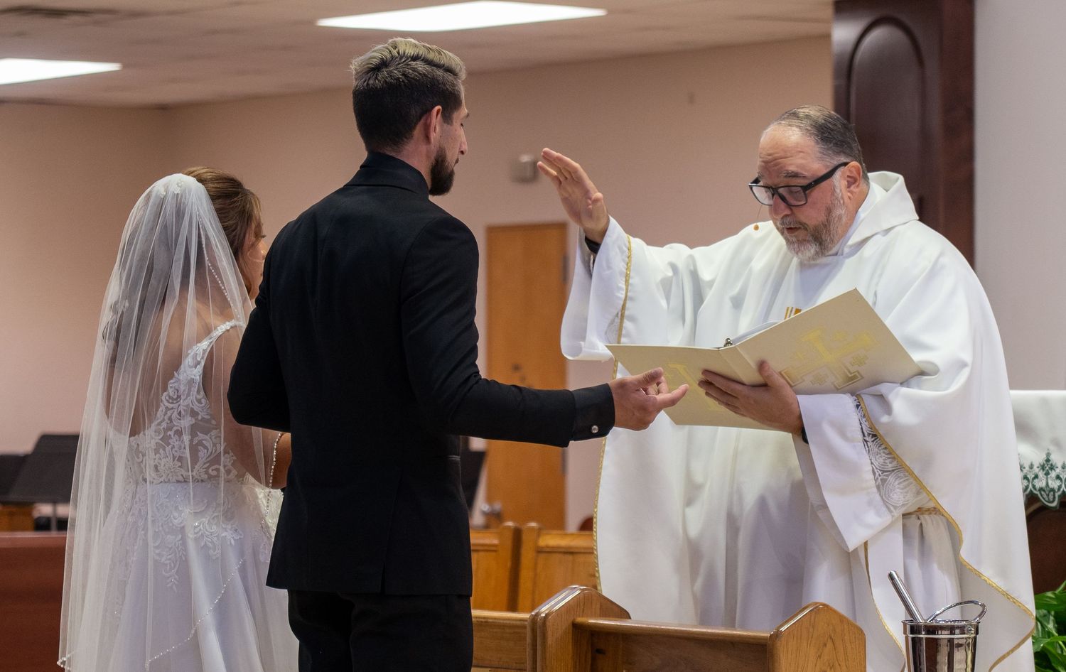 A series of photos showing a wedding ceremony taking place in a church with clergy and couples in formal attire.