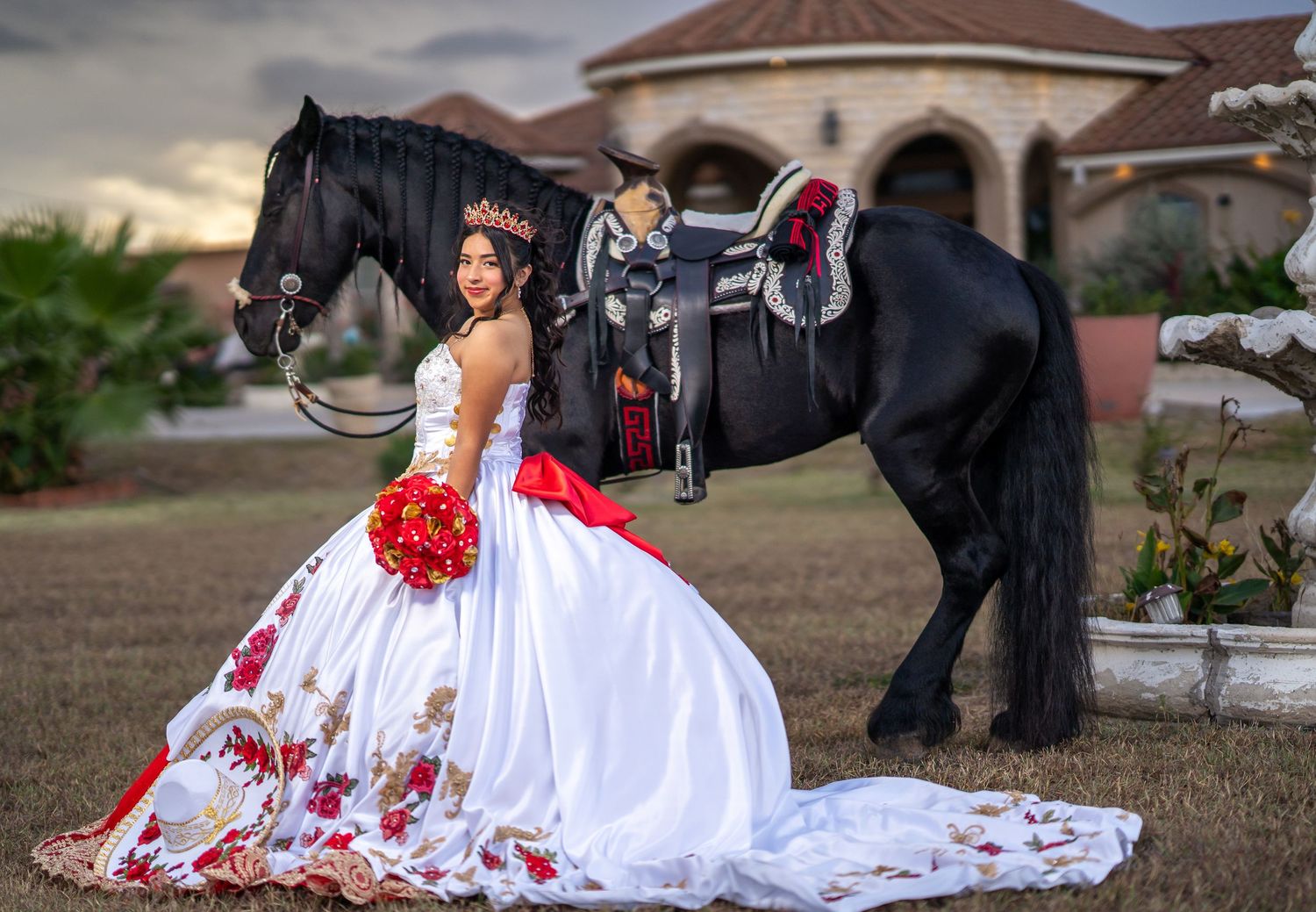 Outdoor celebration photos featuring elegant red and white gown against Spanish-style architecture.