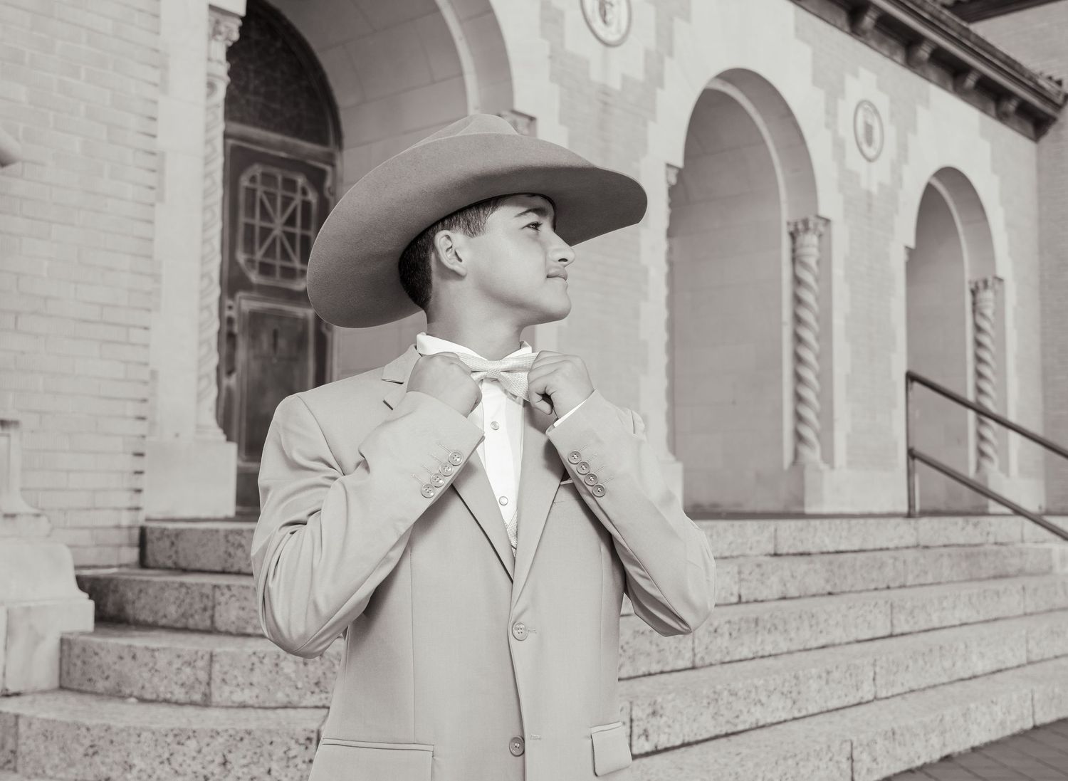 A series of black and white photographs showing a person in a cowboy hat posing against a white building exterior.