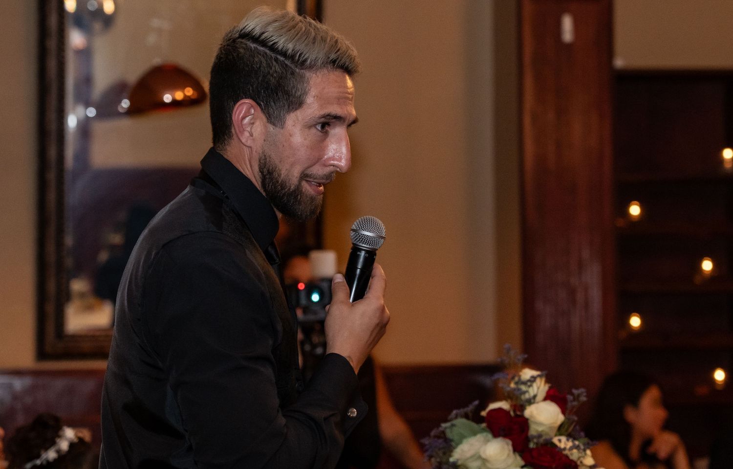 Wedding reception entertainment with speakers and lighting setup in an elegant venue.