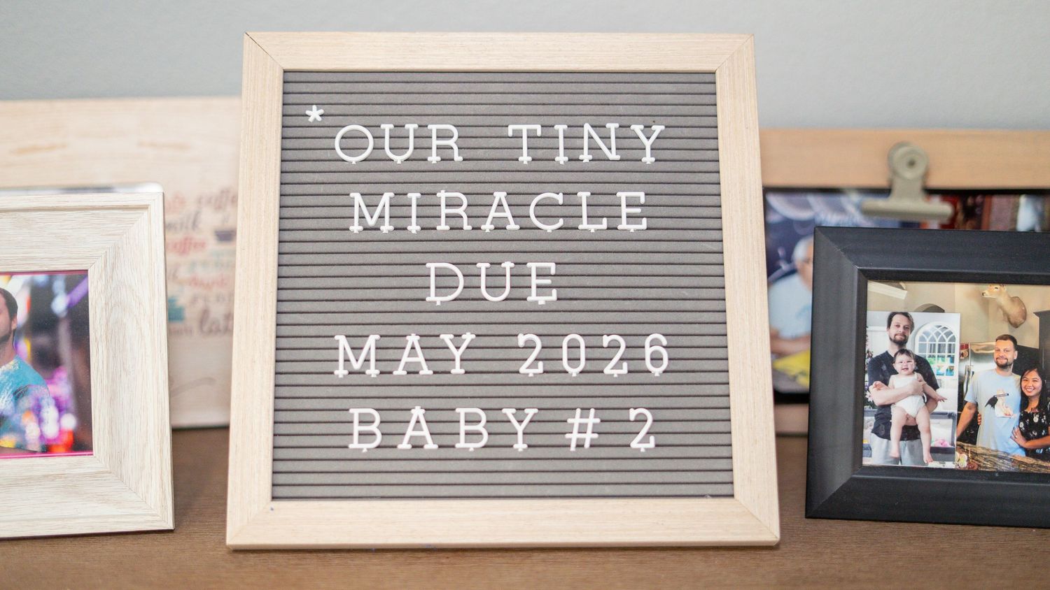 Letter board sign announcing Our Tiny Miracle due May 2026 Baby #2 pregnancy announcement.