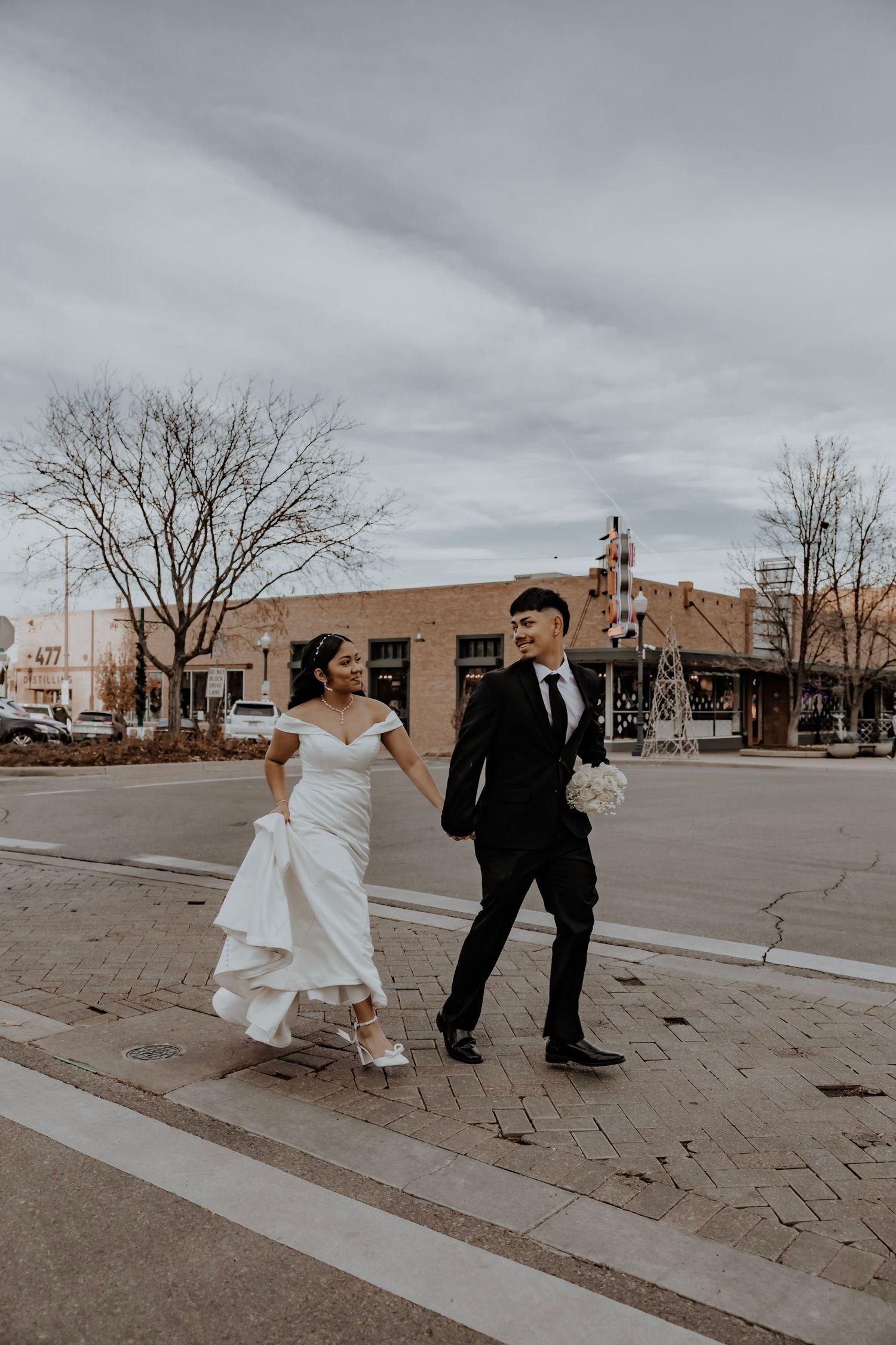 Bride and groom walking across the street