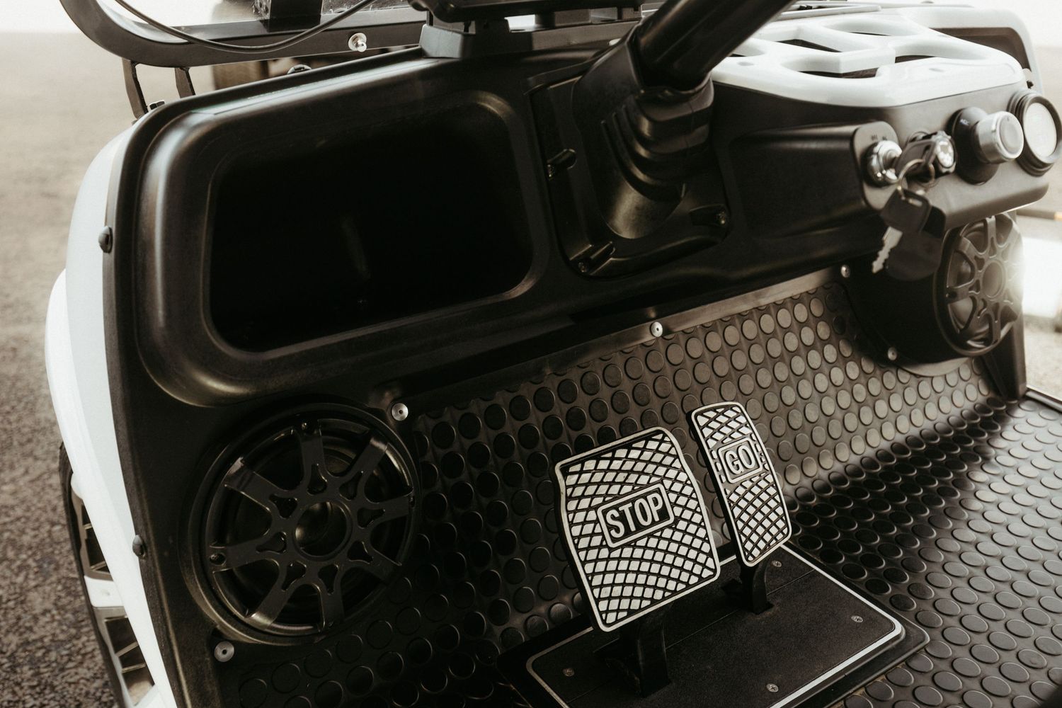 Black and silver car pedals with diamond plate pattern and manual transmission setup shown in monochrome detail.