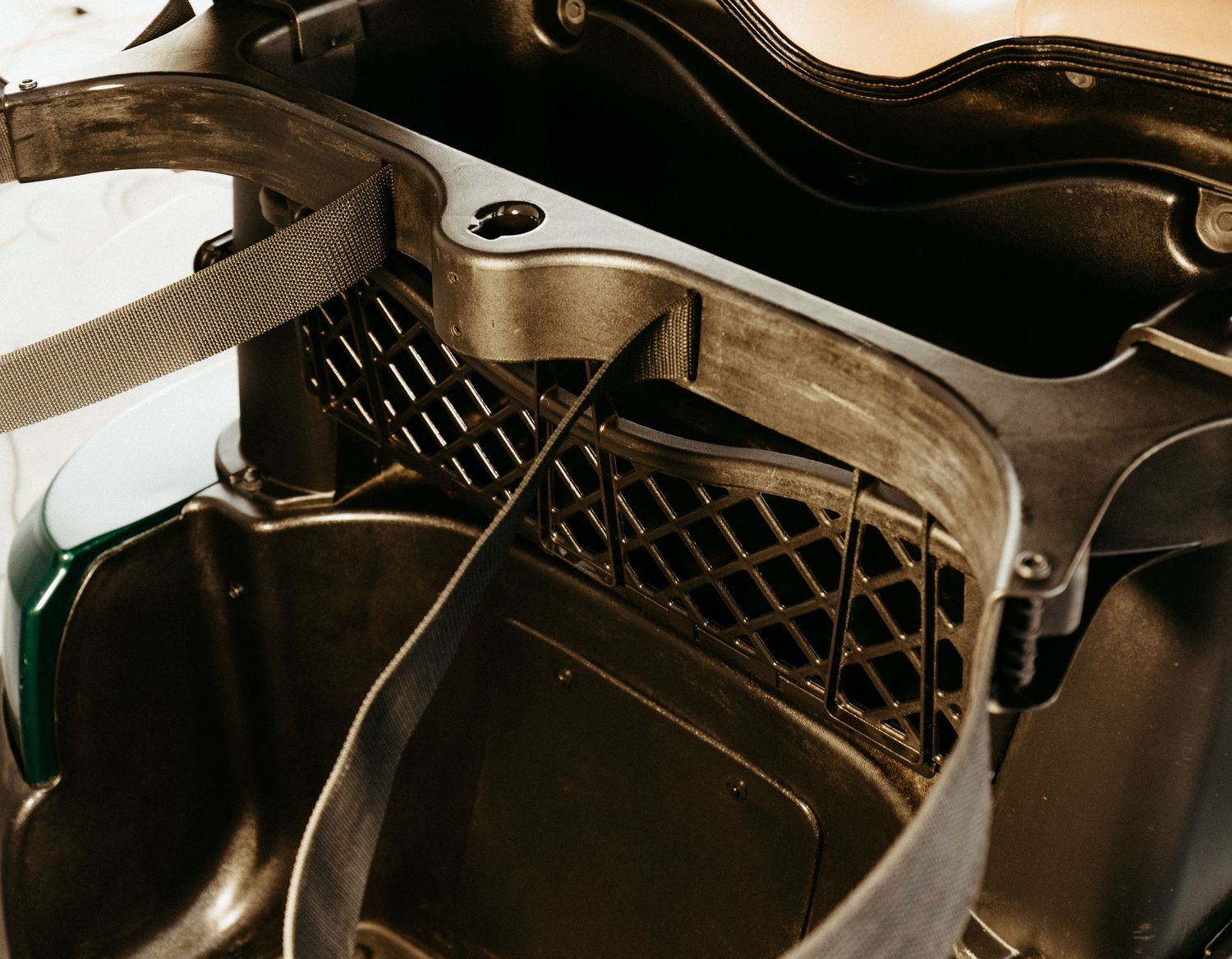 Close-up view of a black automotive engine compartment showing interior parts and ventilation details.