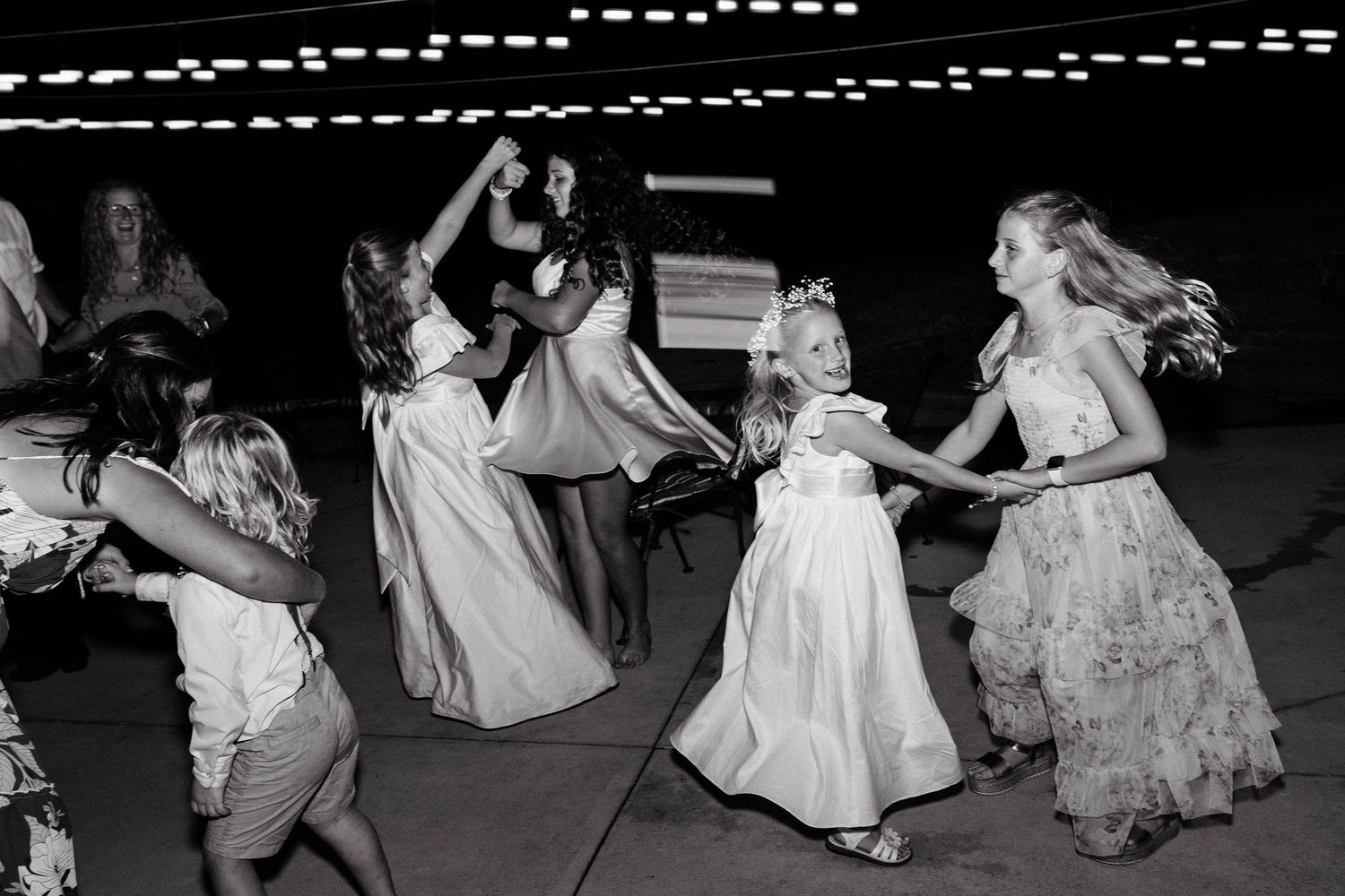 Black and white photos of wedding guests dancing at a reception.