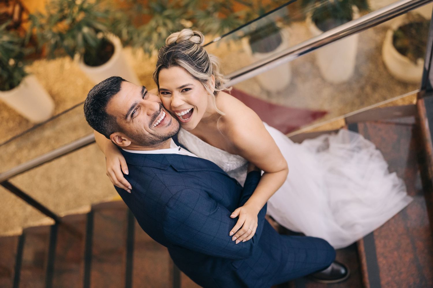A couple shares an intimate moment on outdoor steps during their wedding photoshoot.