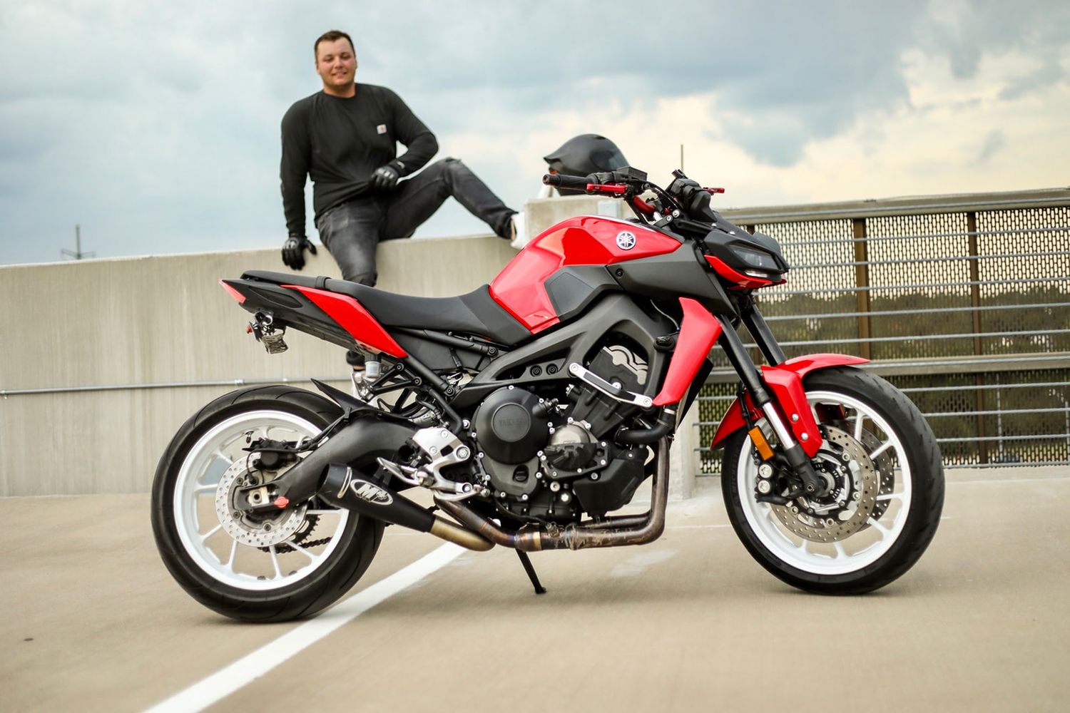 Red sports motorcycle displayed from multiple angles on an elevated roadway.