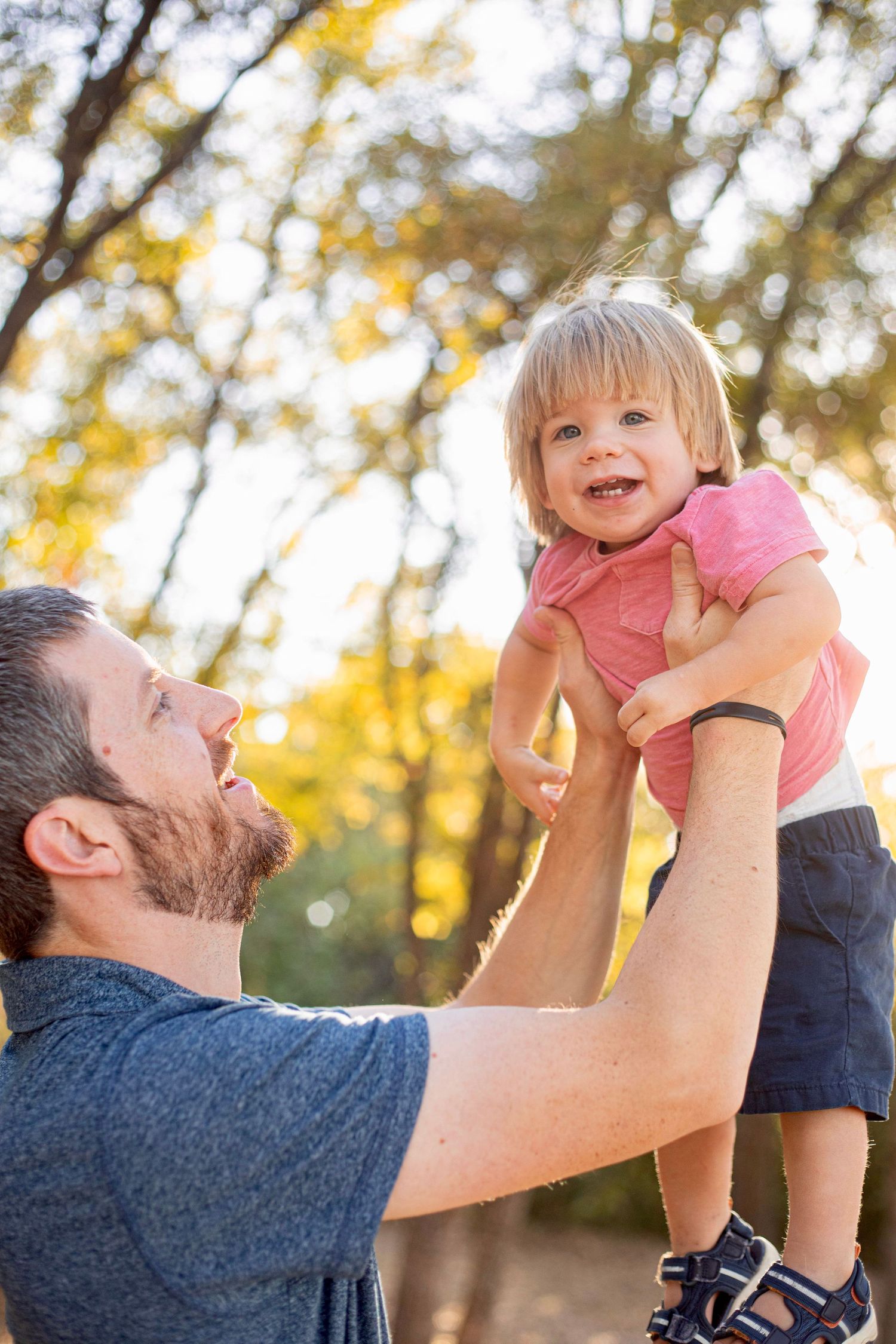 A joyful moment between parent and child against a golden autumn background.