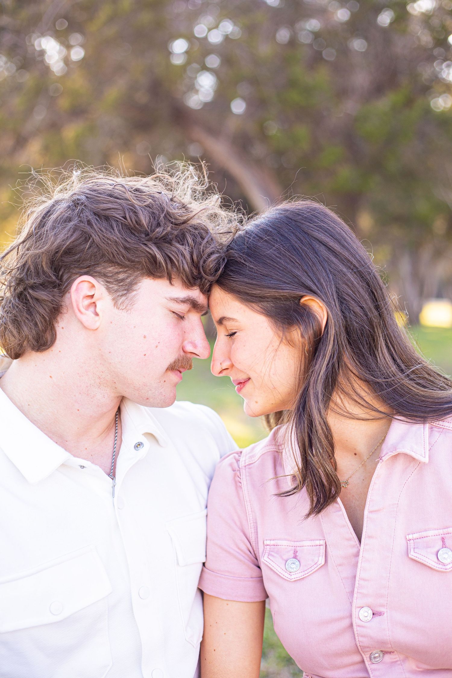 A couple shares intimate close-up moments in soft natural lighting.