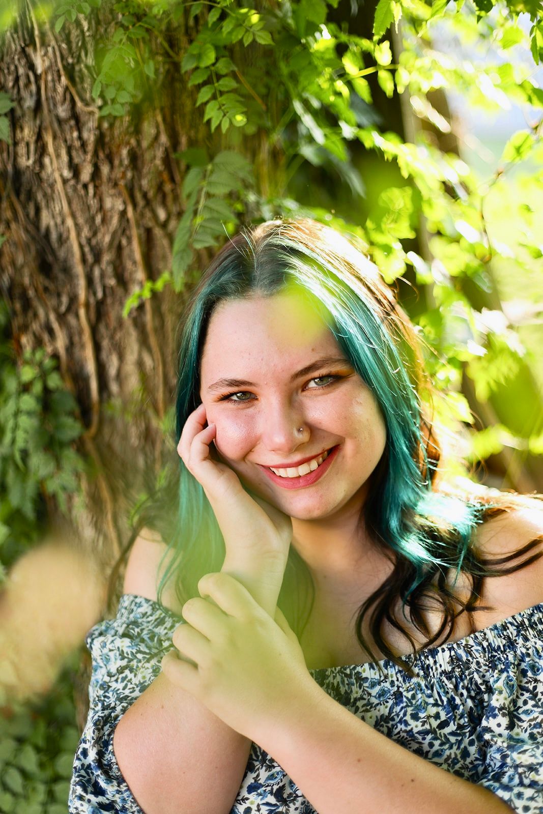 Outdoor portrait series with natural lighting and tree backdrop.