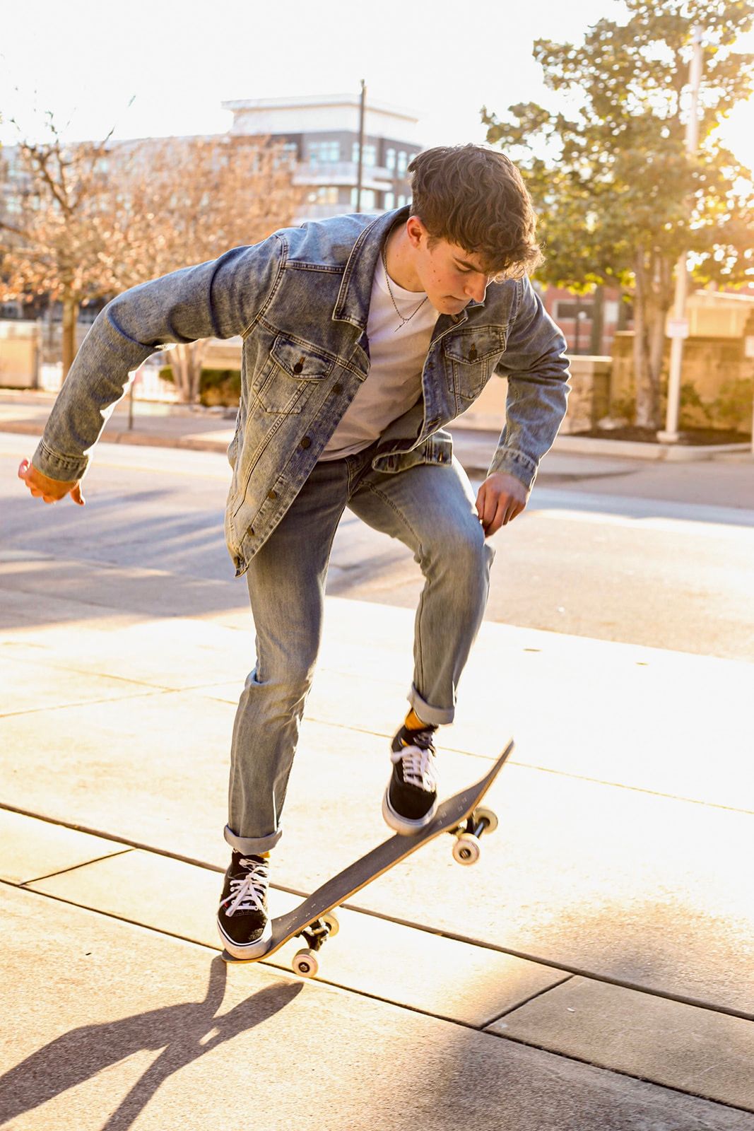 Action shots of skateboarding moves on an urban concrete surface in denim attire.